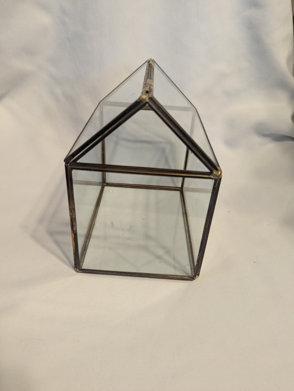 Small house shaped metal and glass terrarium