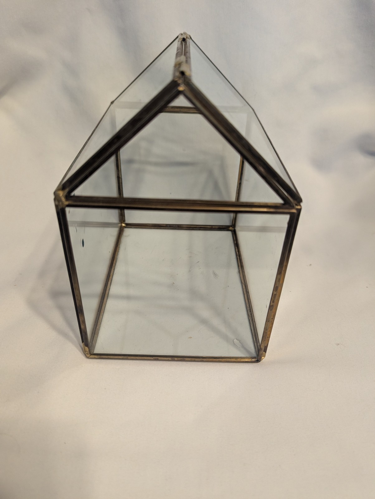 Small house shaped metal and glass terrarium