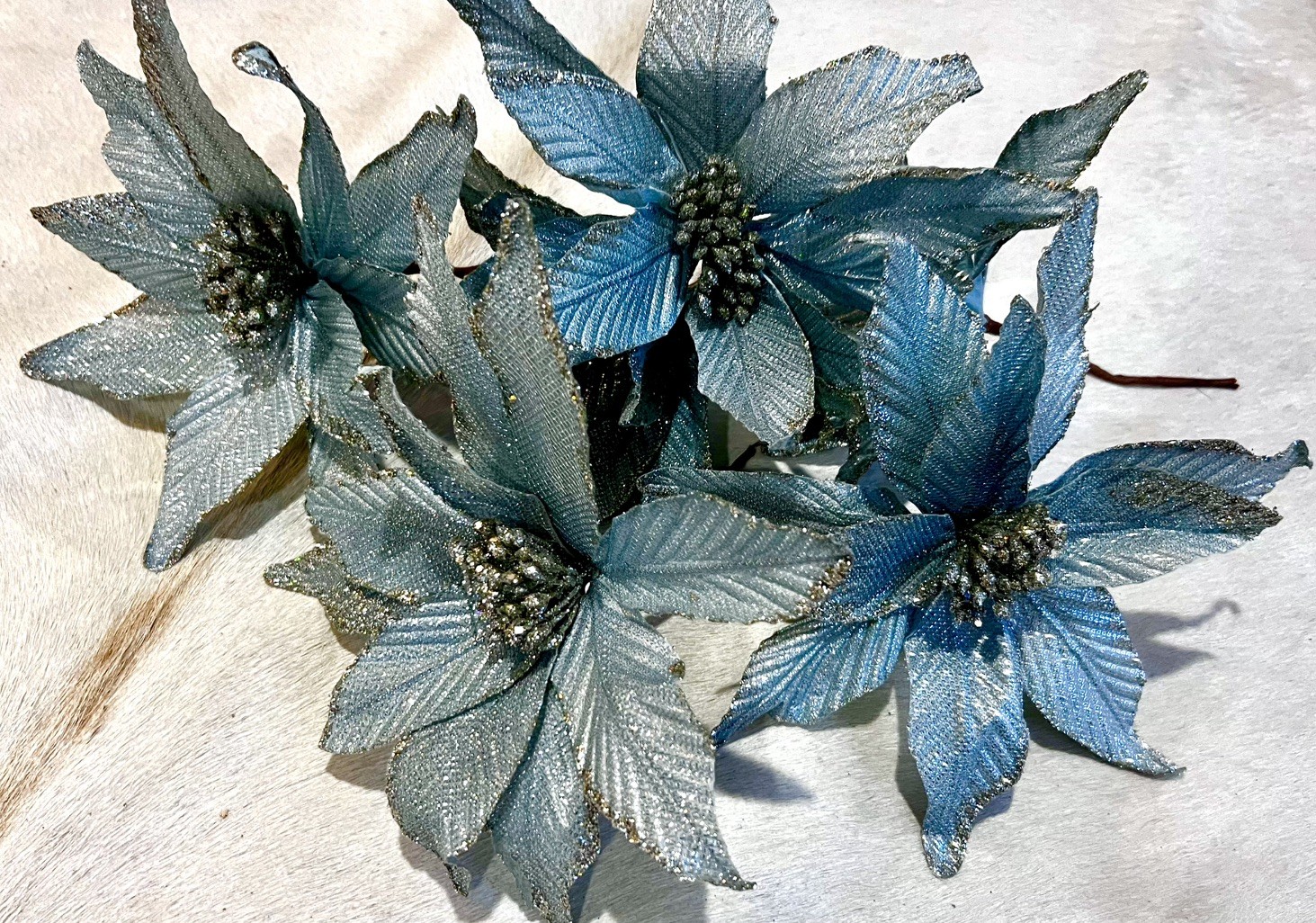 poinsettia flowers in a metallic Blue & silver used as decorations for Christmas