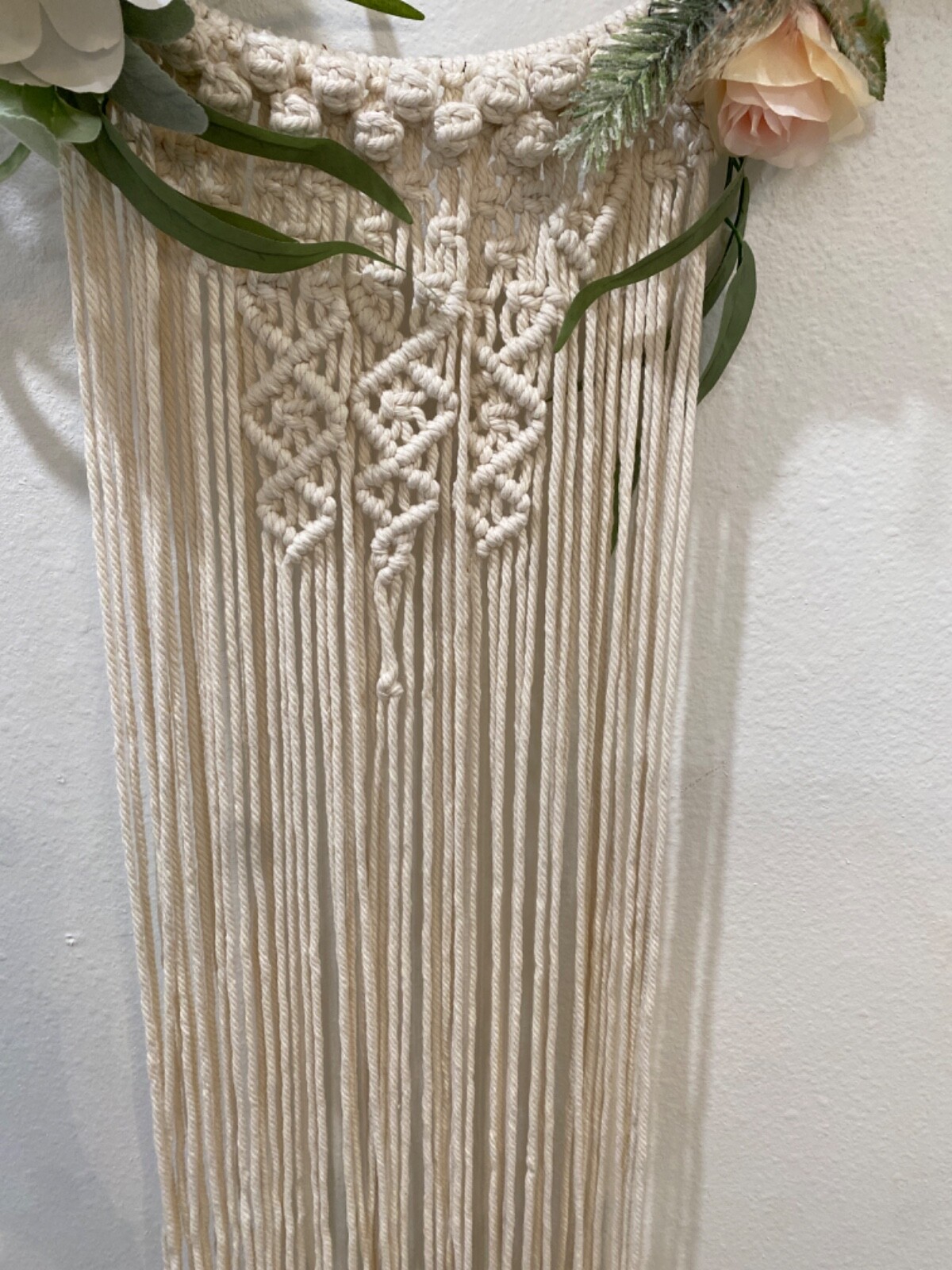 Macramé Boho pastel colored flowered wreath. Measures 58 inches in length