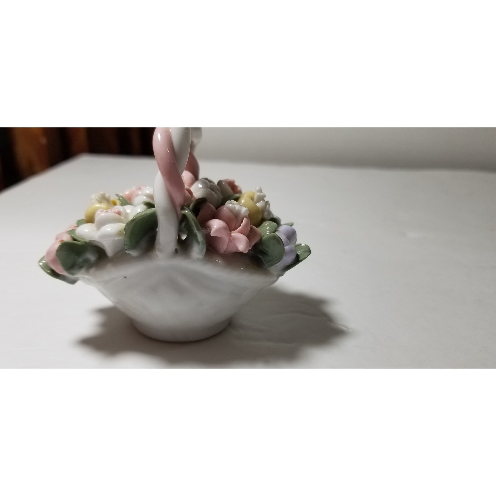 Three inch by 3 inch hand painted porcelain basket (1.1282)
