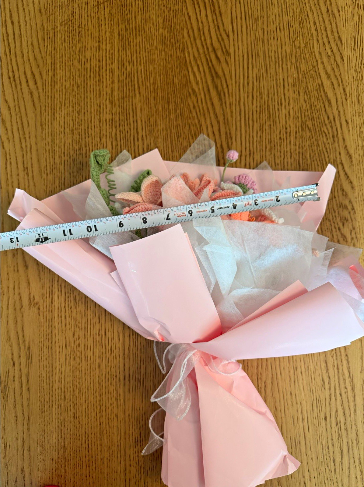 A beautiful handmade crochet flower bouquet, carefully crafted in soft pink, whi