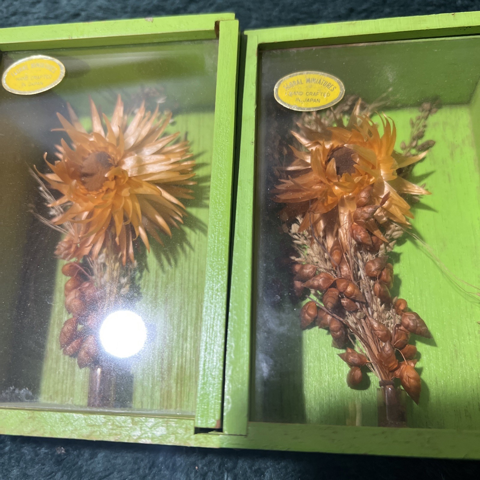 Two Modern Decorative Boxes Containing Dried Orange Flowers and Seed Pods. New