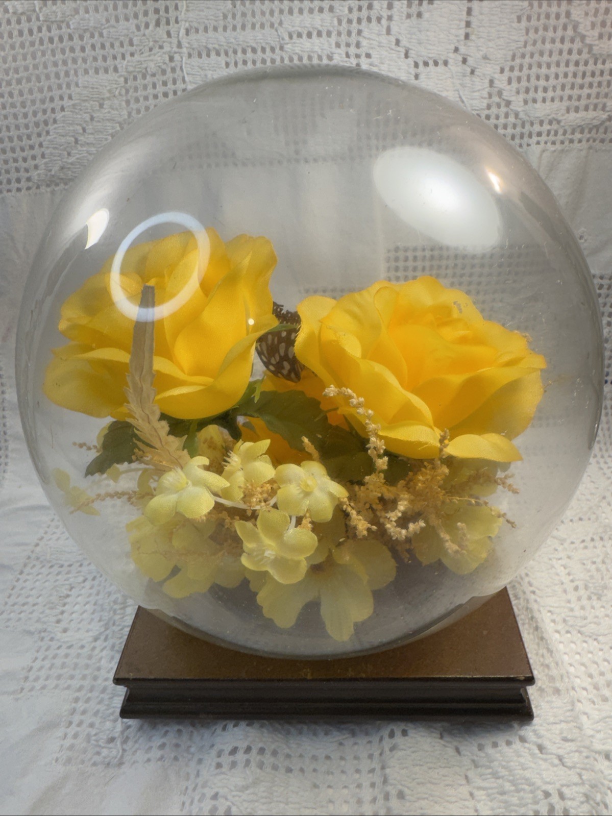 Vintage preserved flower arrangement in glass dome