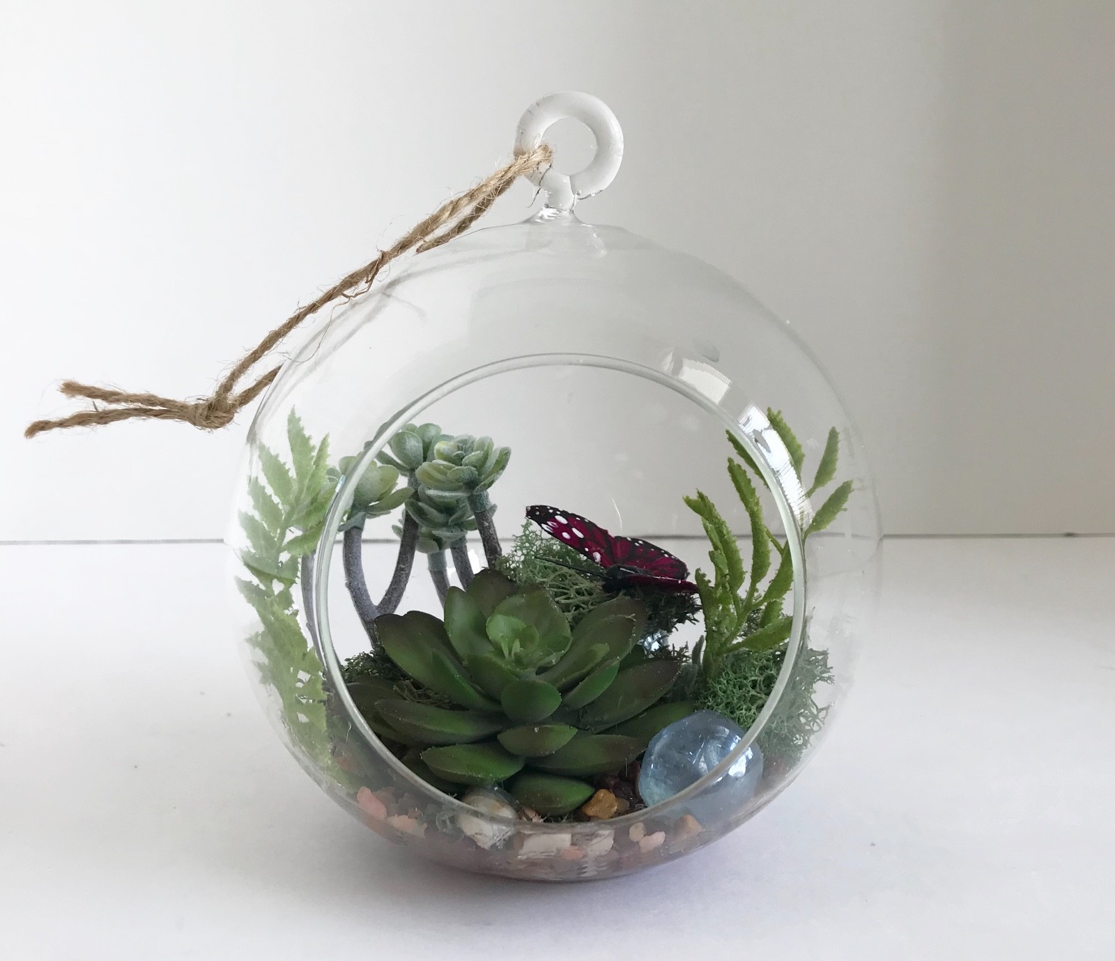 Hanging Round Glass Vase with Artificial Green Grass Succulents and a Purple But