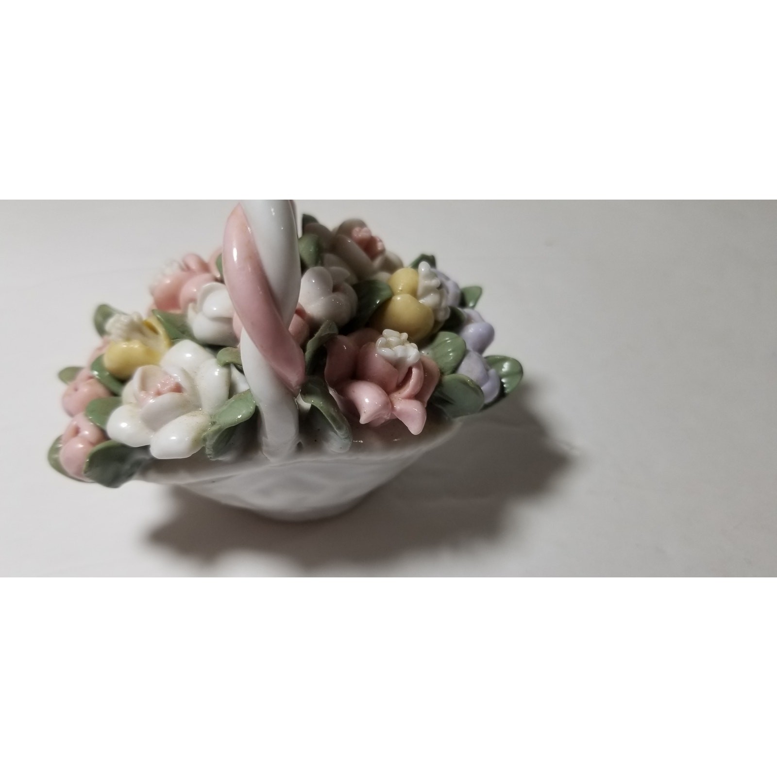 Three inch by 3 inch hand painted porcelain basket (1.1282)