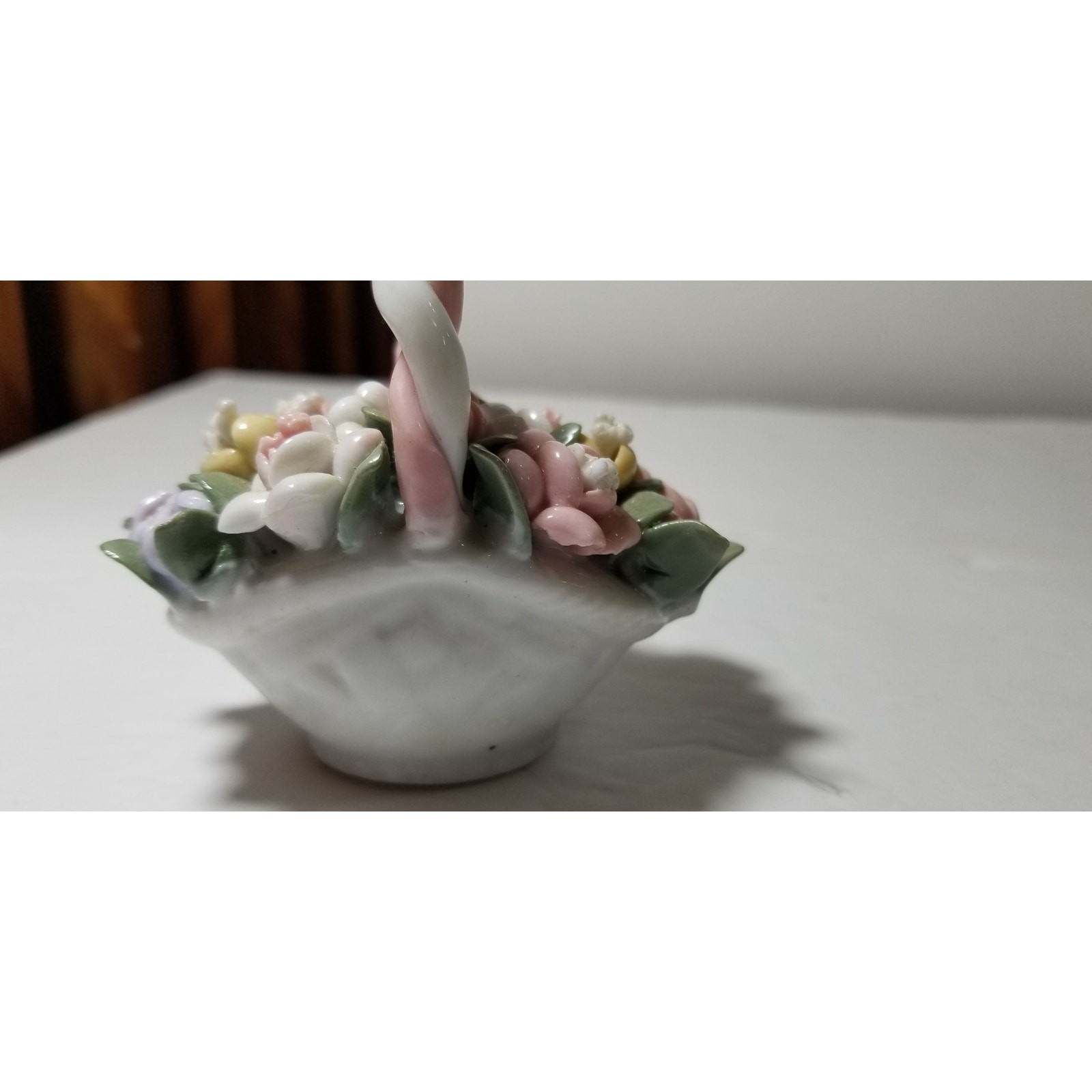 Three inch by 3 inch hand painted porcelain basket (1.1282)