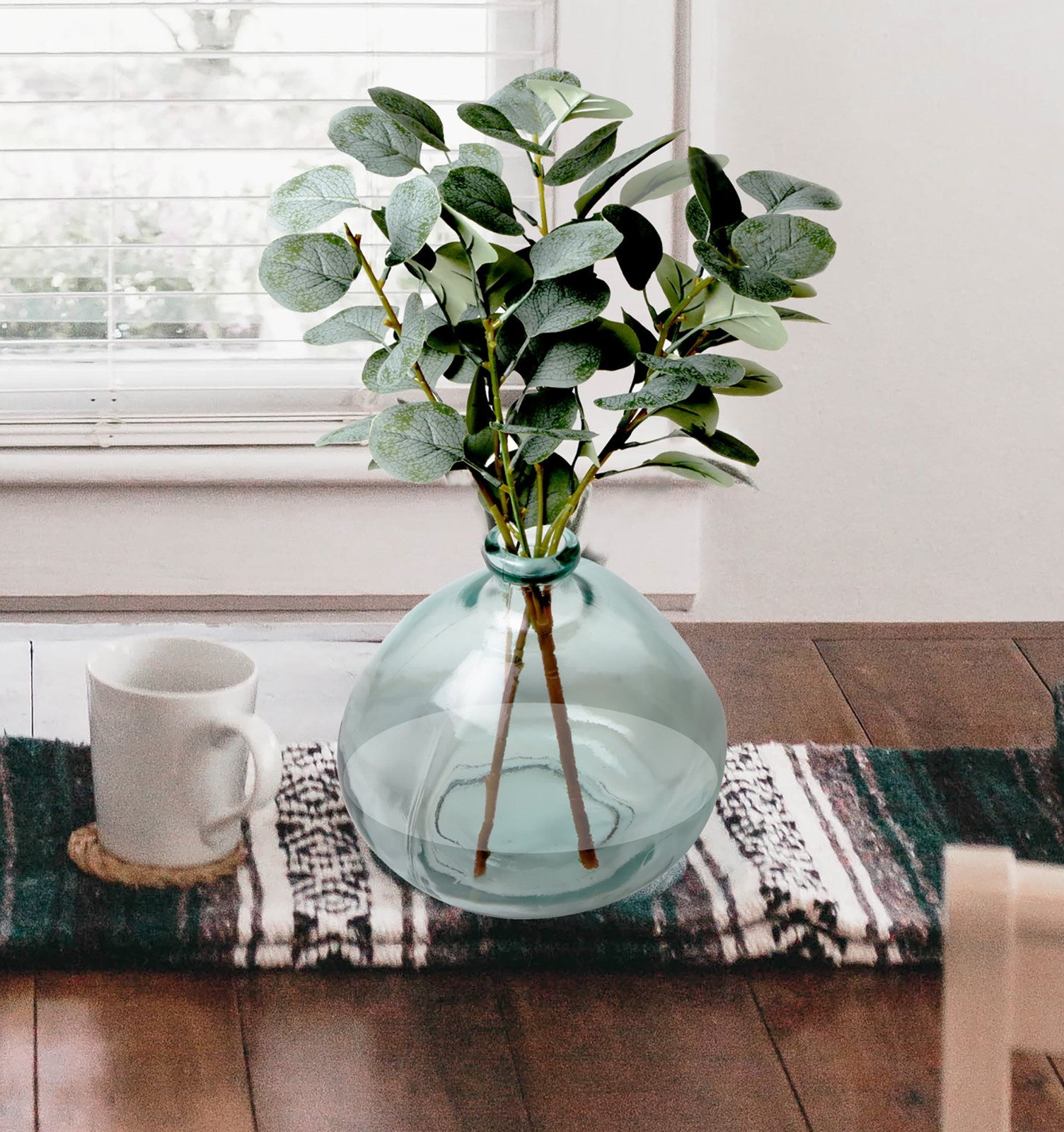 Artificial Green Eucalyptus Leaf Stems in Large Clear Blown Glass Vase