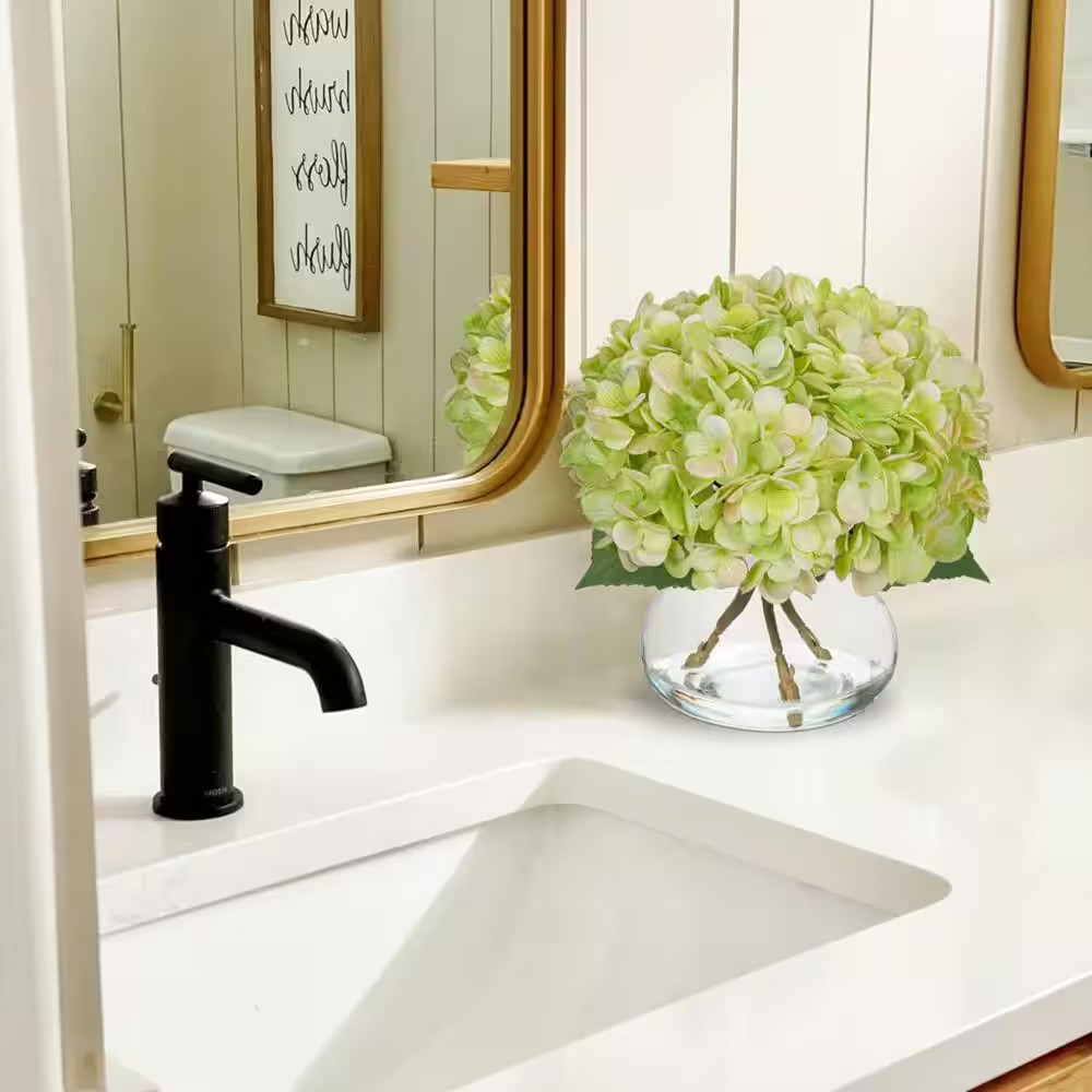 Green Artificial Flowers Paired with a Glass Vase