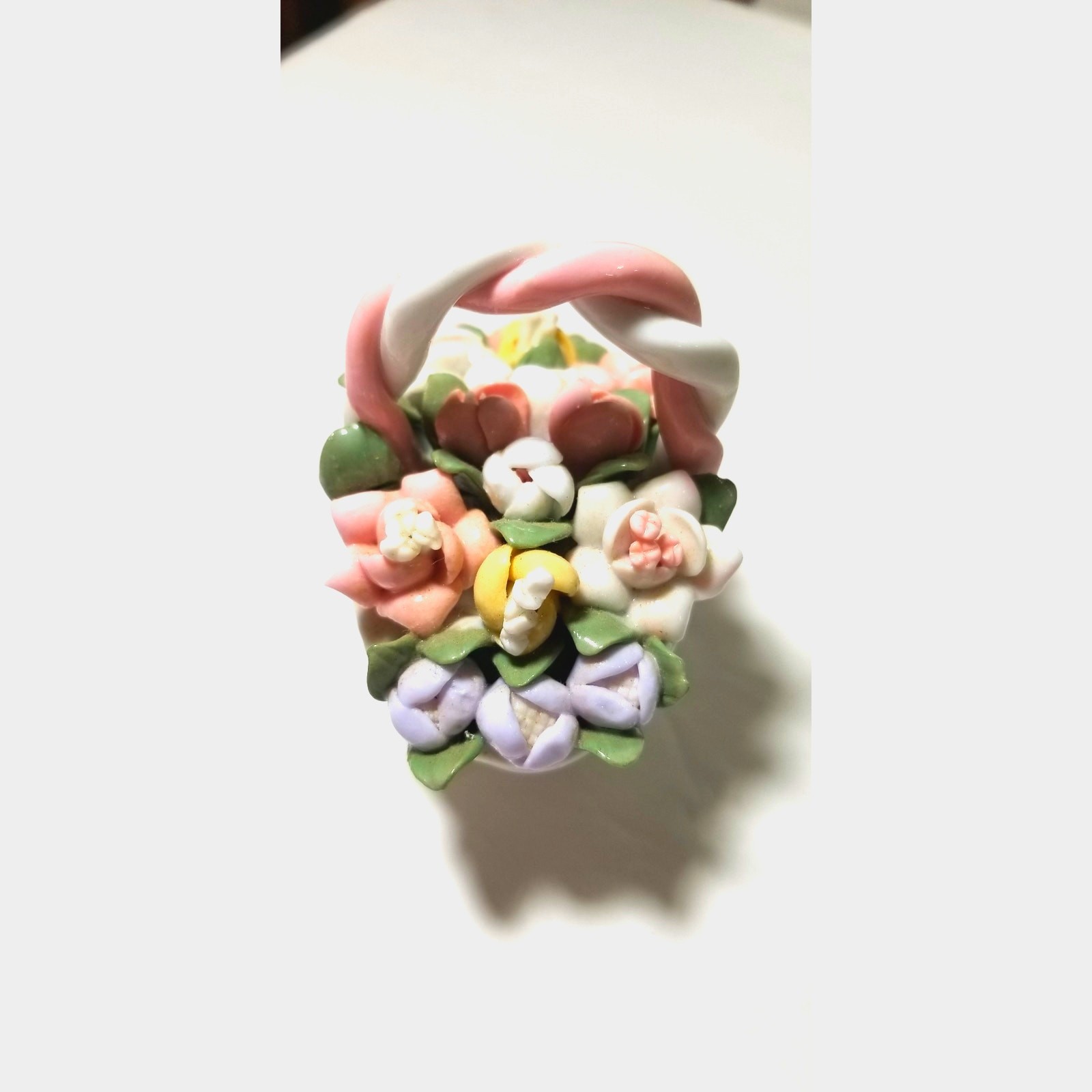 Three inch by 3 inch hand painted porcelain basket (1.1282)