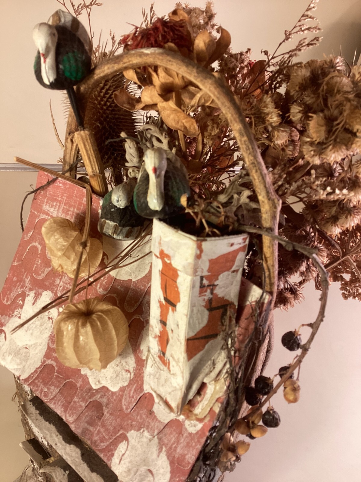 Wood birdhouse centerpiece with dried flowers, turkeys, twigs, windows, chimney