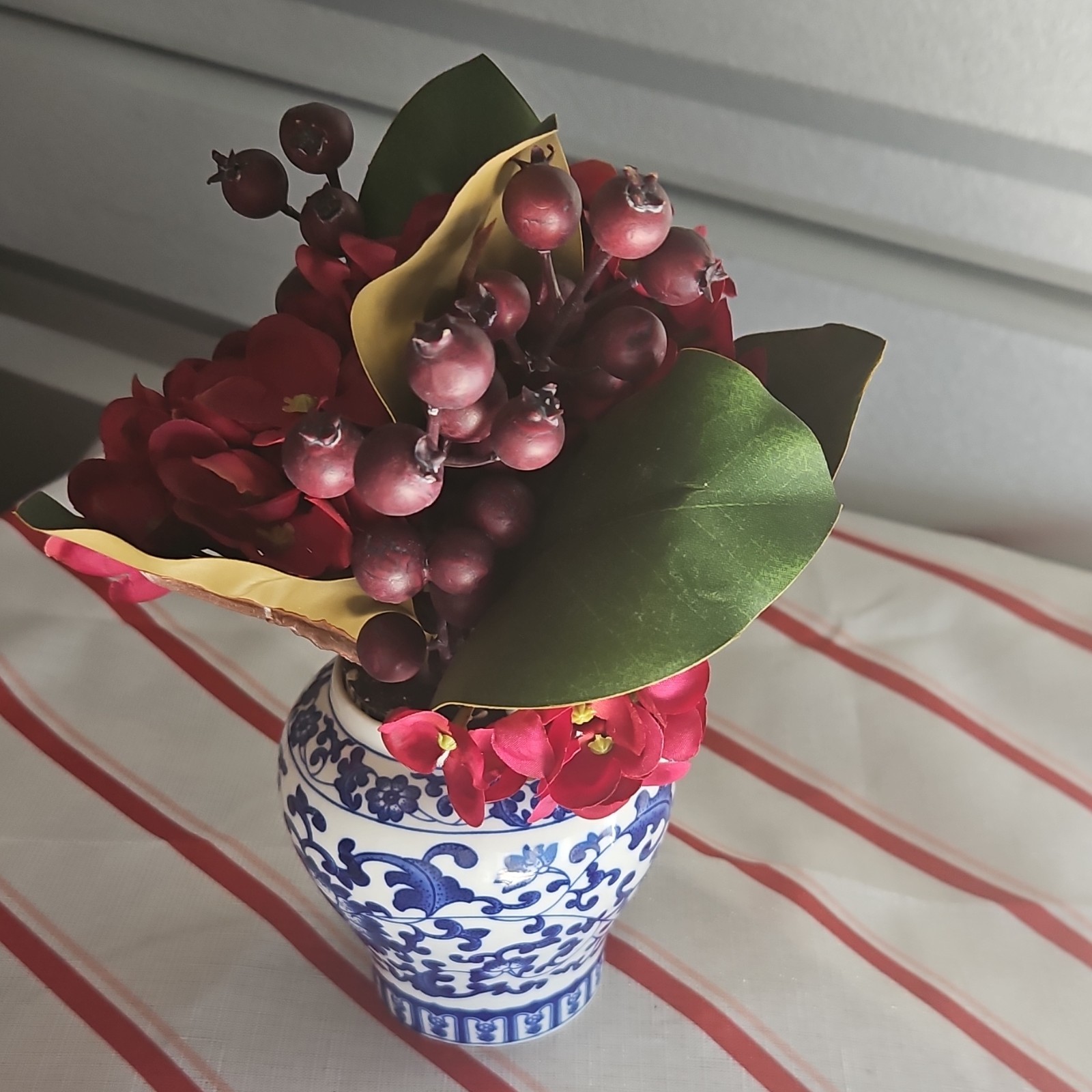 Artificial Red Flower Arrangement with Greenery in Blue and White Vase