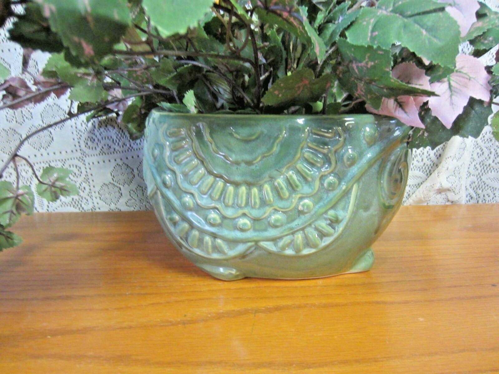 Green Elephant Planter With Green Foliage and Small Orange Flowers