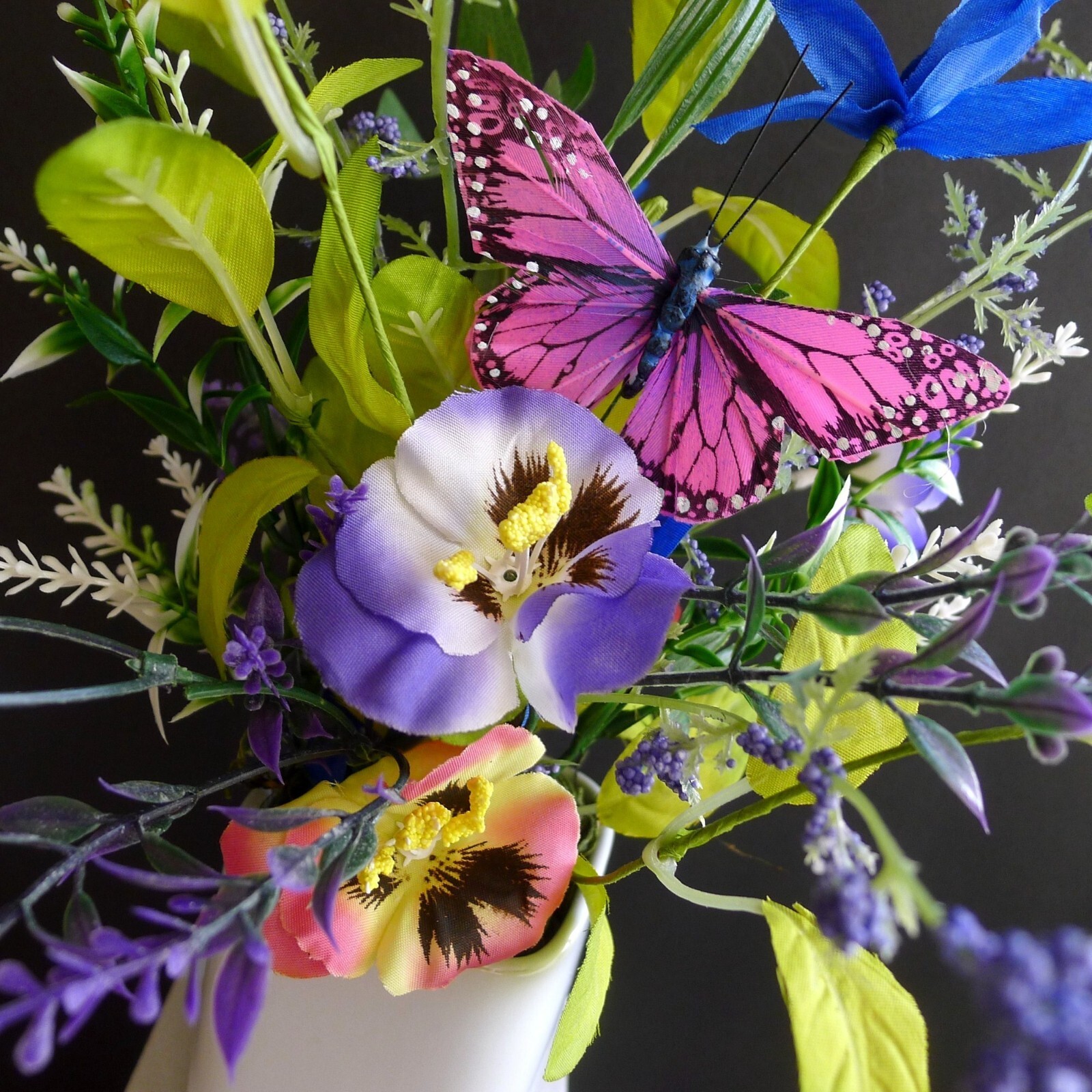 Wildflower Pansy Floral Arrangement Pink Feather Butterfly and a White Planter
