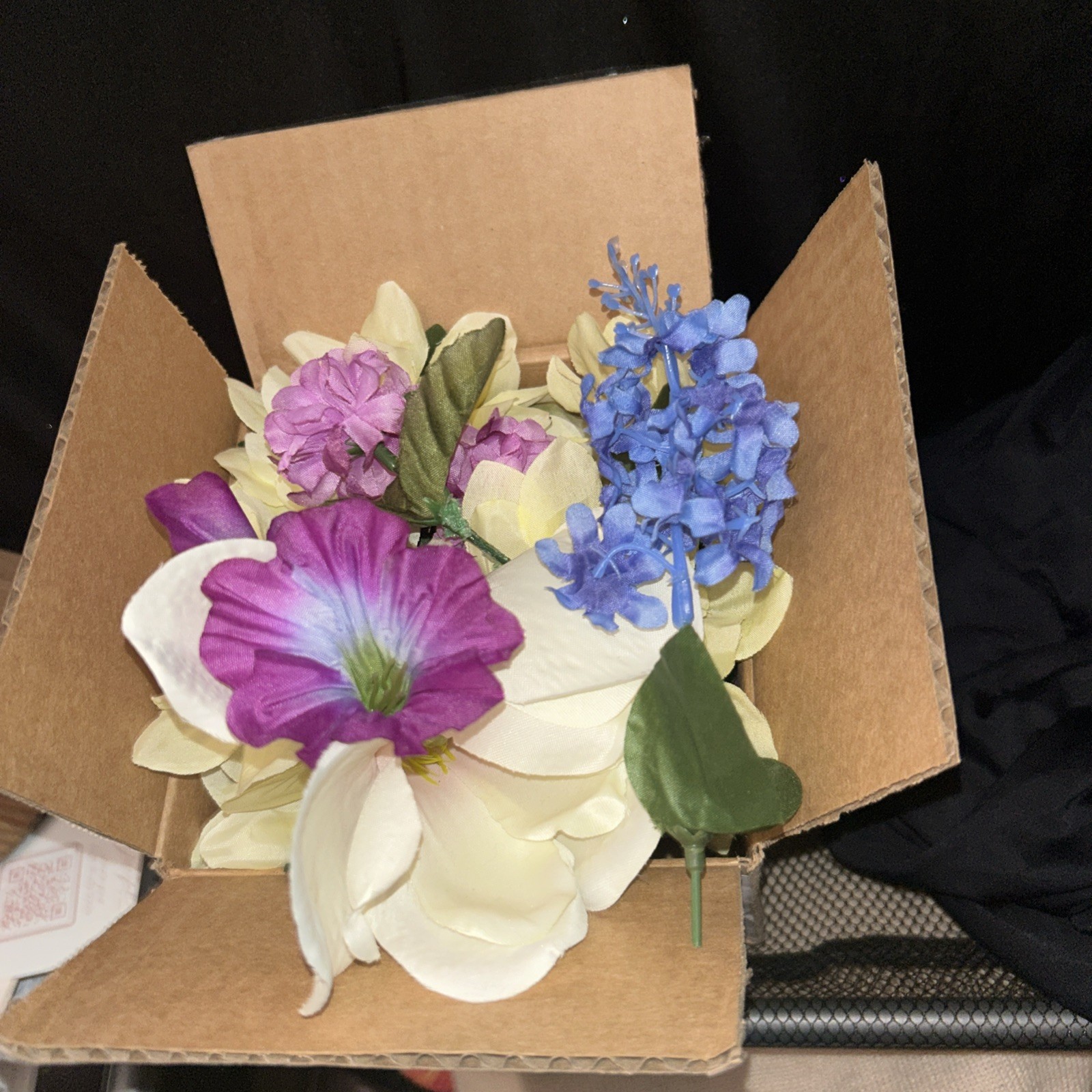 Box Full Of Fake Flowers Purple Blue And White Off White With Stems And Green