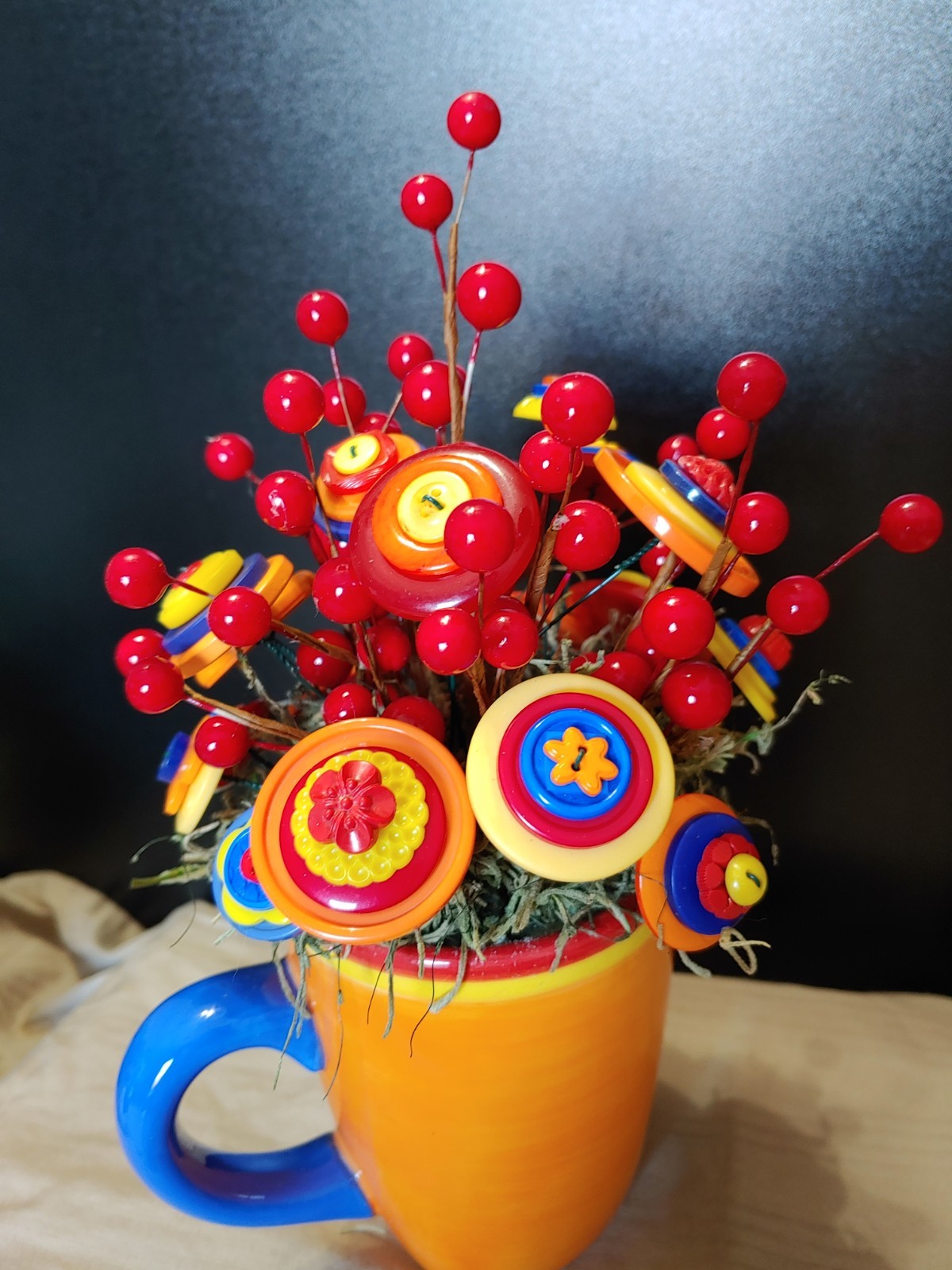 Bright Button Bouquet in Orange Coffee Mug. Red, orange, yellow. fun and playful