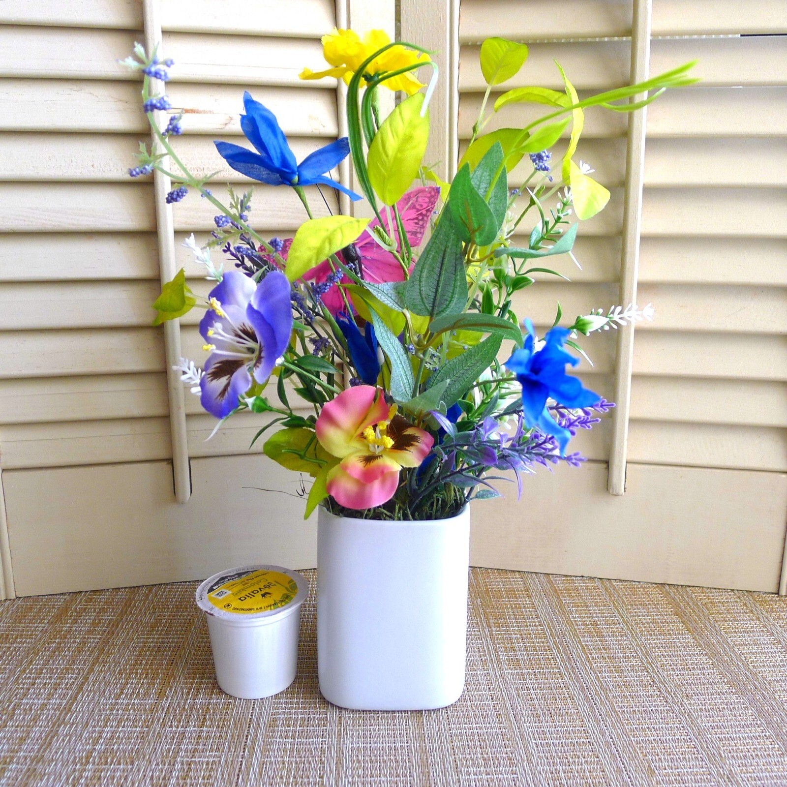 Wildflower Pansy Floral Arrangement Pink Feather Butterfly and a White Planter