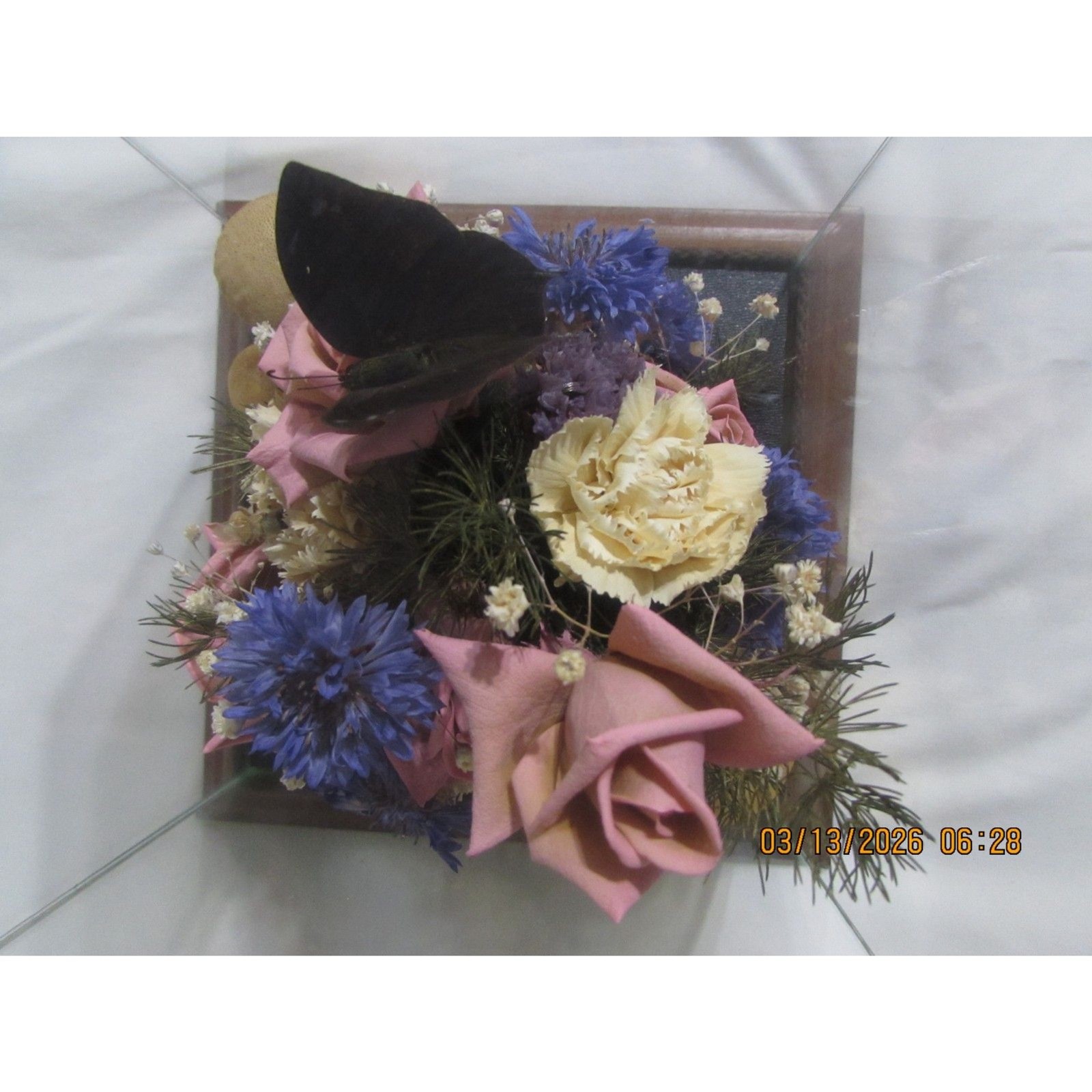 Vintage dried flower arrangement in glass with wood base butterfly mushrooms