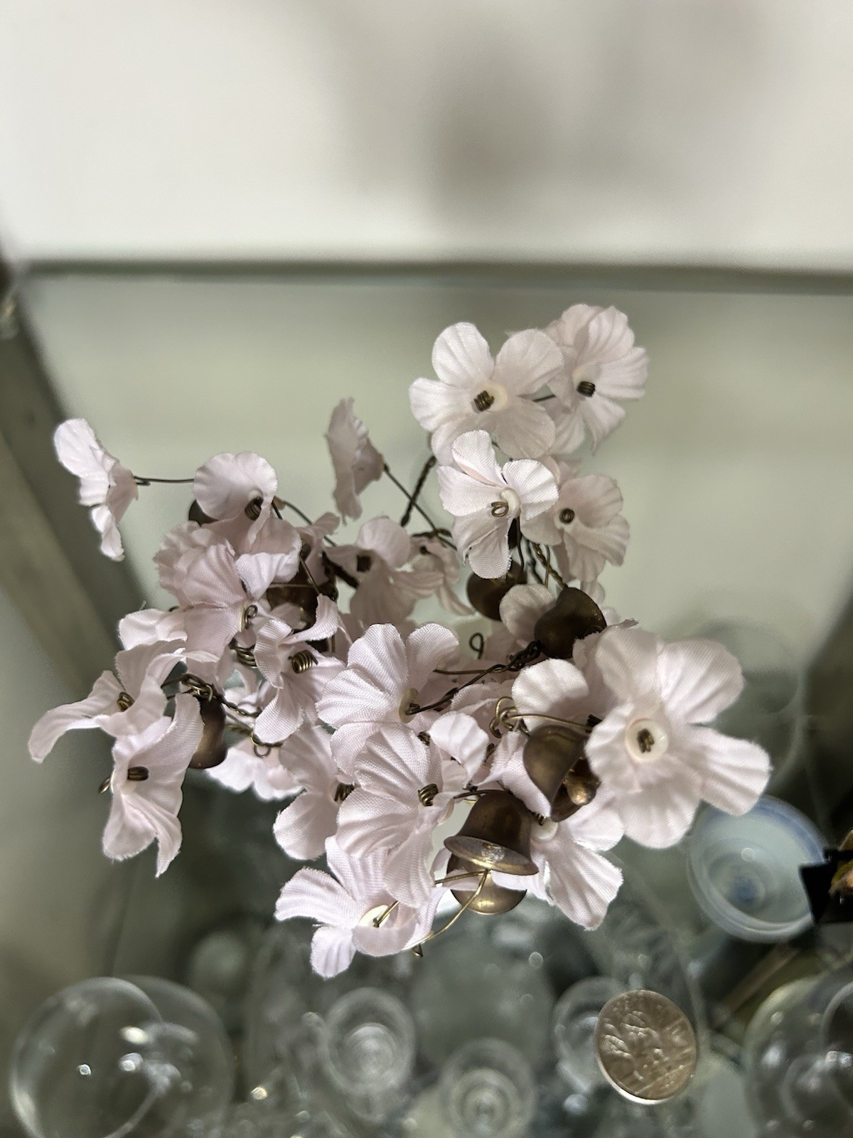 vintage wire prosperity tree with silk flowers and brass bells on a marble base