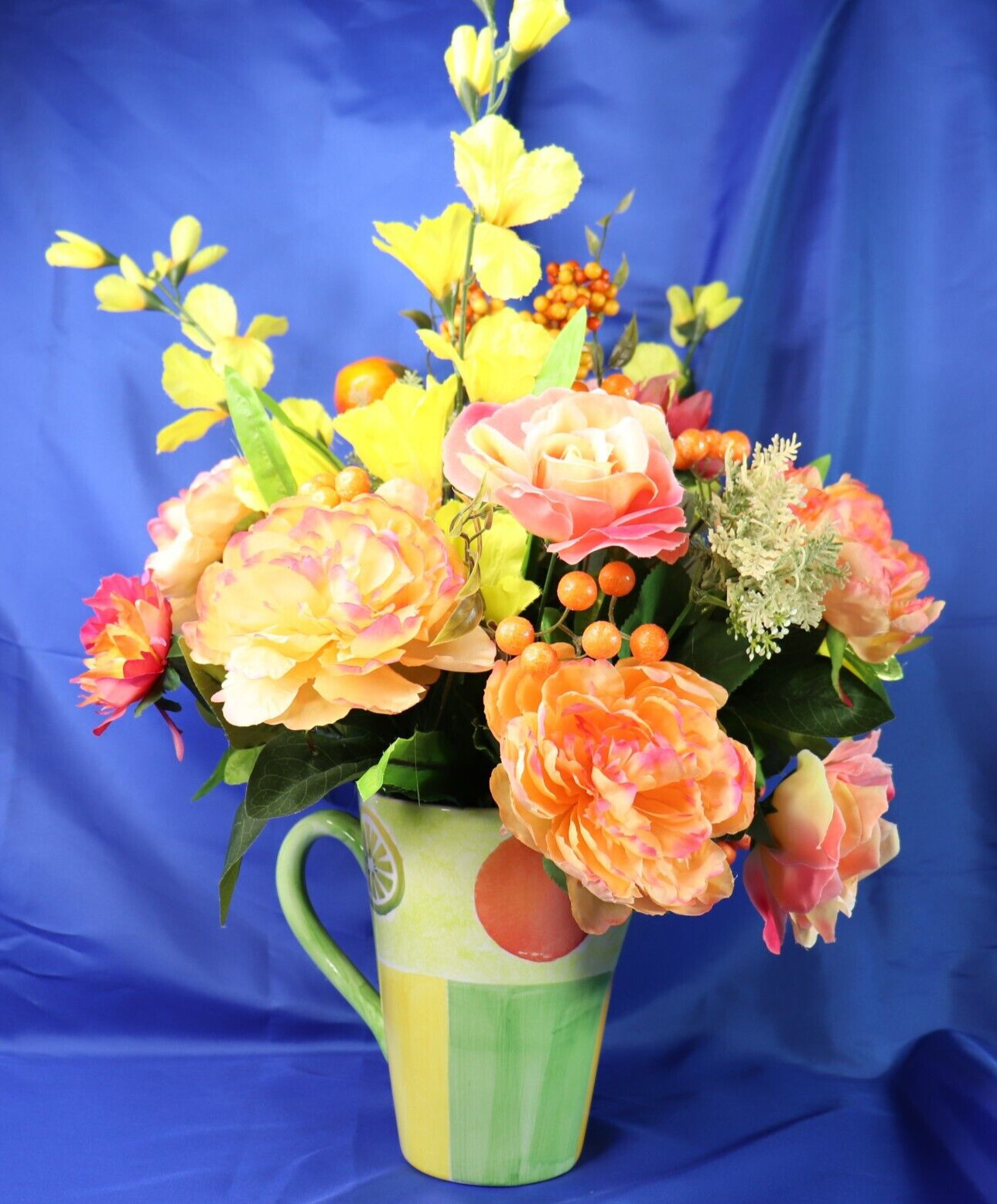 Very Colorful Floral Arrangement In A Beautiful Pitcher With Limes & Oranges