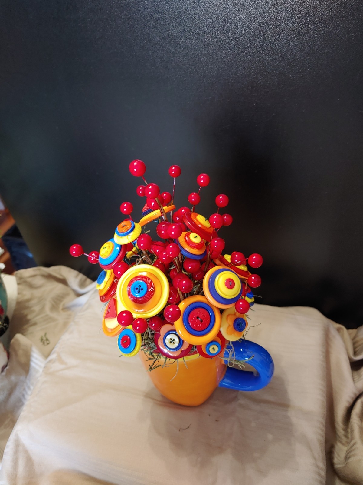 Bright Button Bouquet in Orange Coffee Mug. Red, orange, yellow. fun and playful