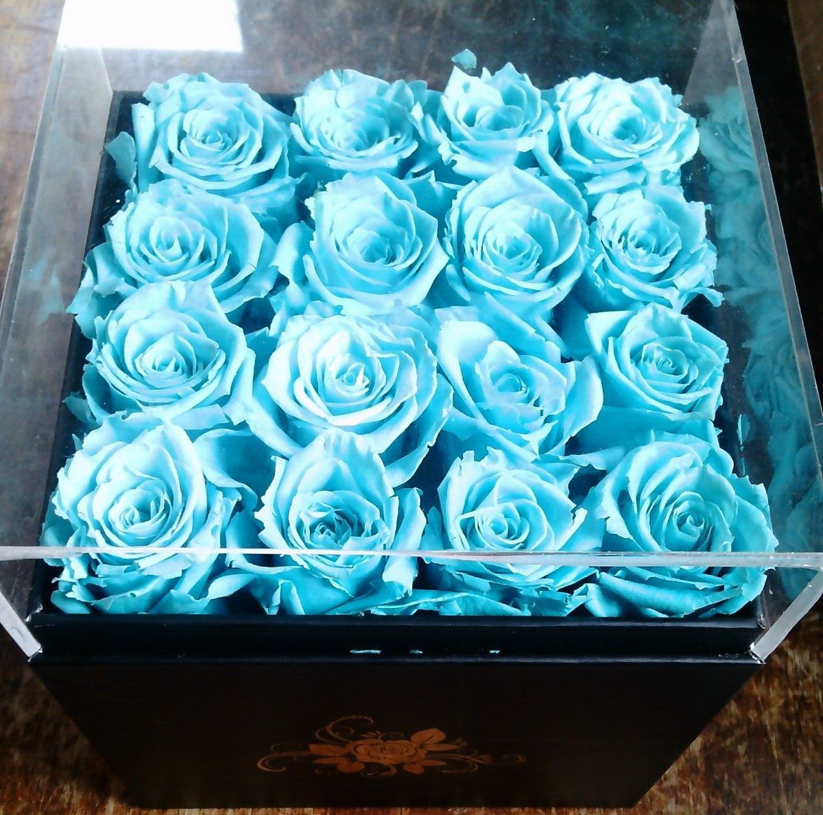 16 aqua preserved roses in (approx.) 6.5 x 6.75 x 7.5 inch black box PLEASE READ