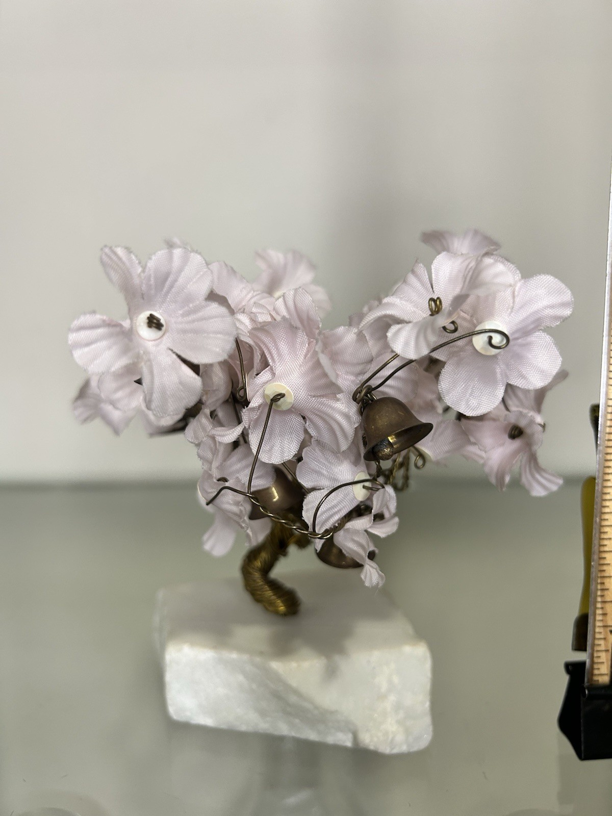 vintage wire prosperity tree with silk flowers and brass bells on a marble base