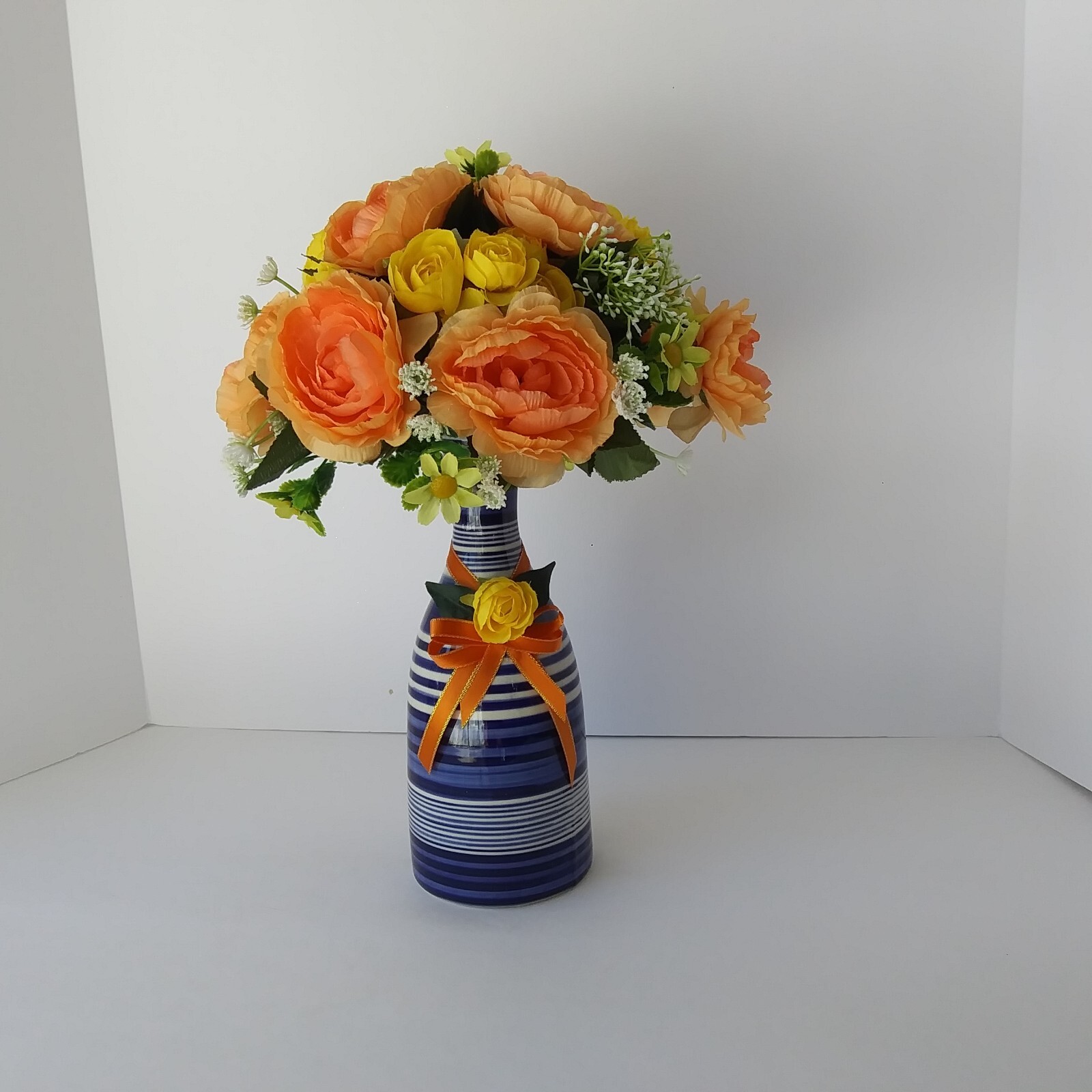 Blue White Striped Pottery Vase with Peach and Yellow Rose Floral Arrangement