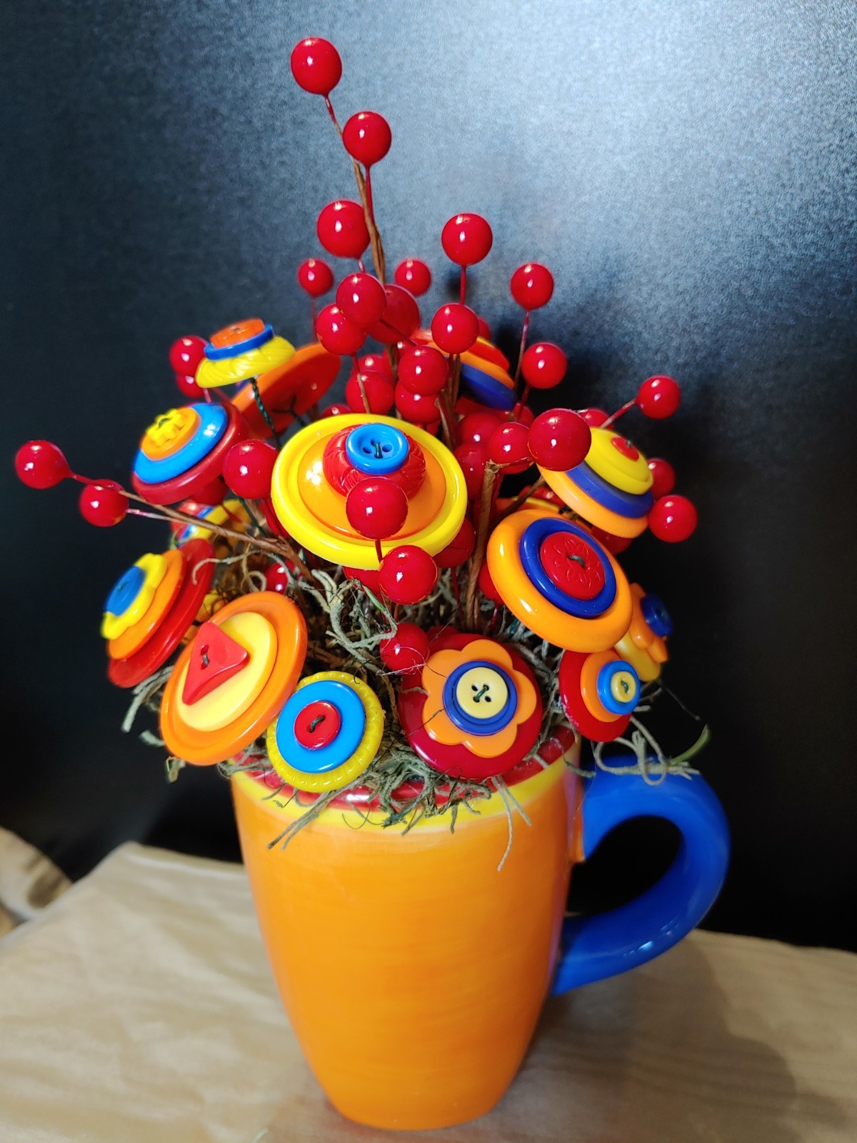 Bright Button Bouquet in Orange Coffee Mug. Red, orange, yellow. fun and playful