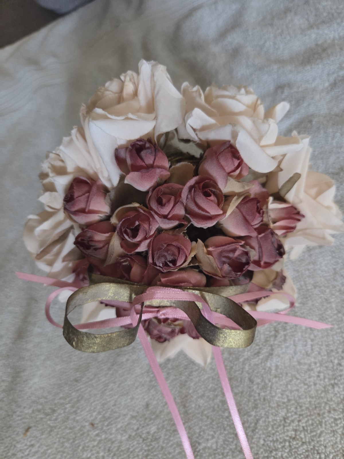 decorative artificial flower arrangement featuring cream and maroon roses
