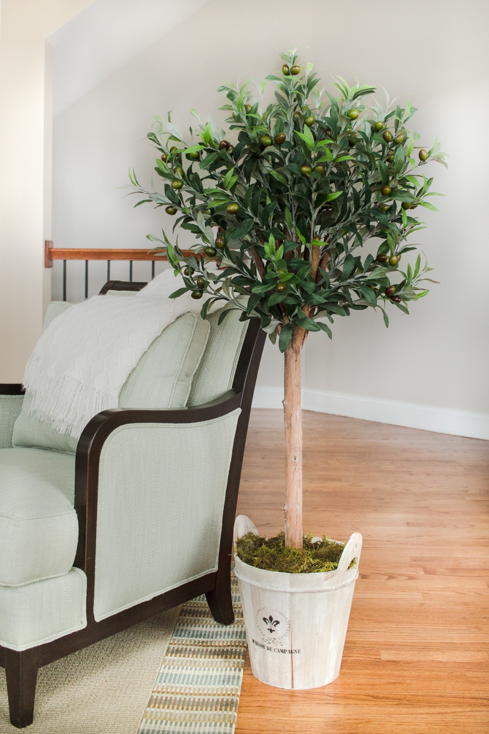 Nearly Natural 4.5ft Olive Topiary Tree with European Barrel Planter in Green