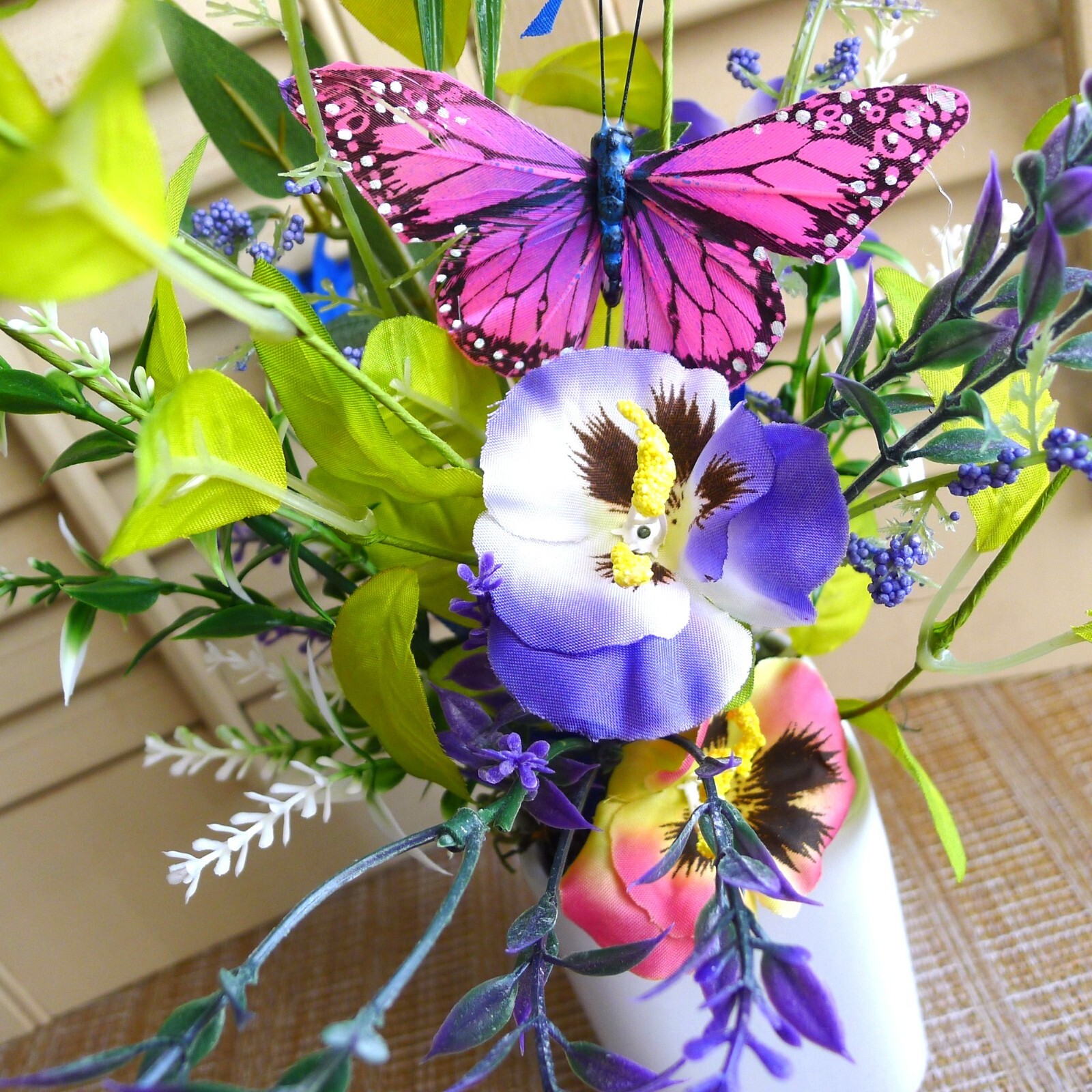 Wildflower Pansy Floral Arrangement Pink Feather Butterfly and a White Planter