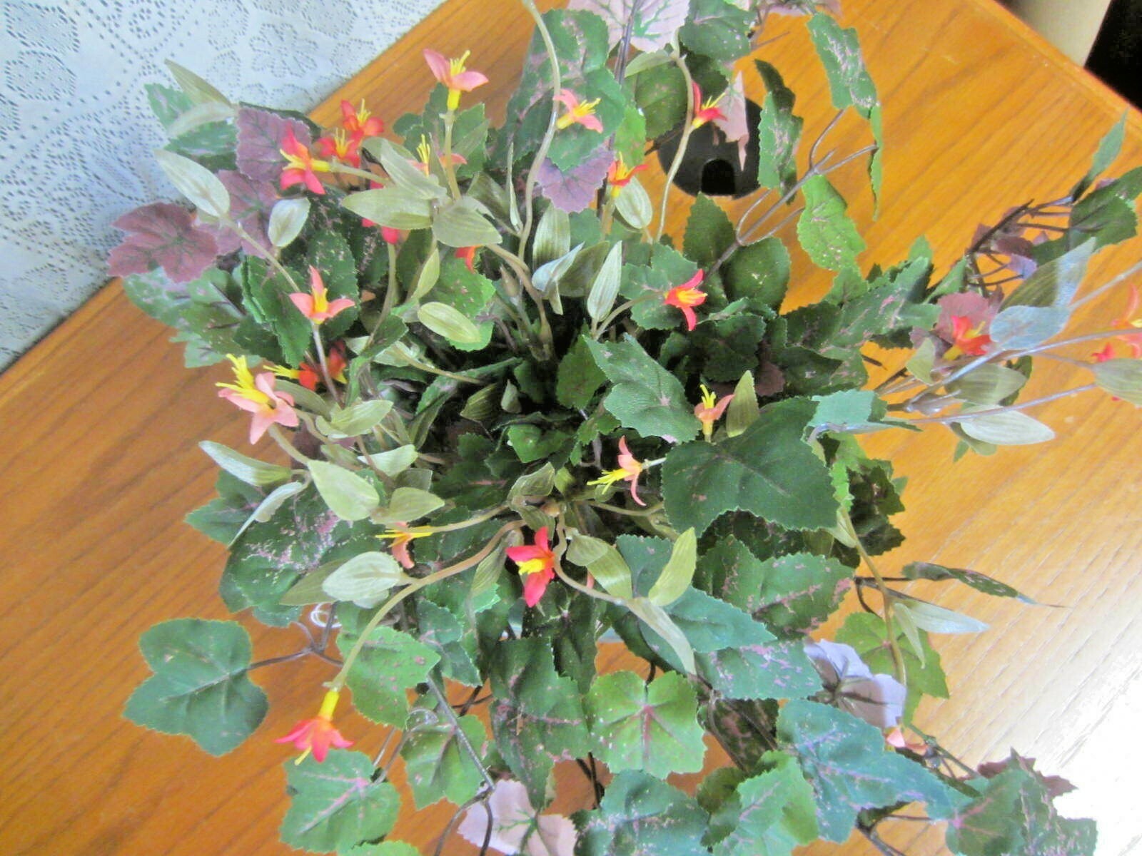 Green Elephant Planter With Green Foliage and Small Orange Flowers