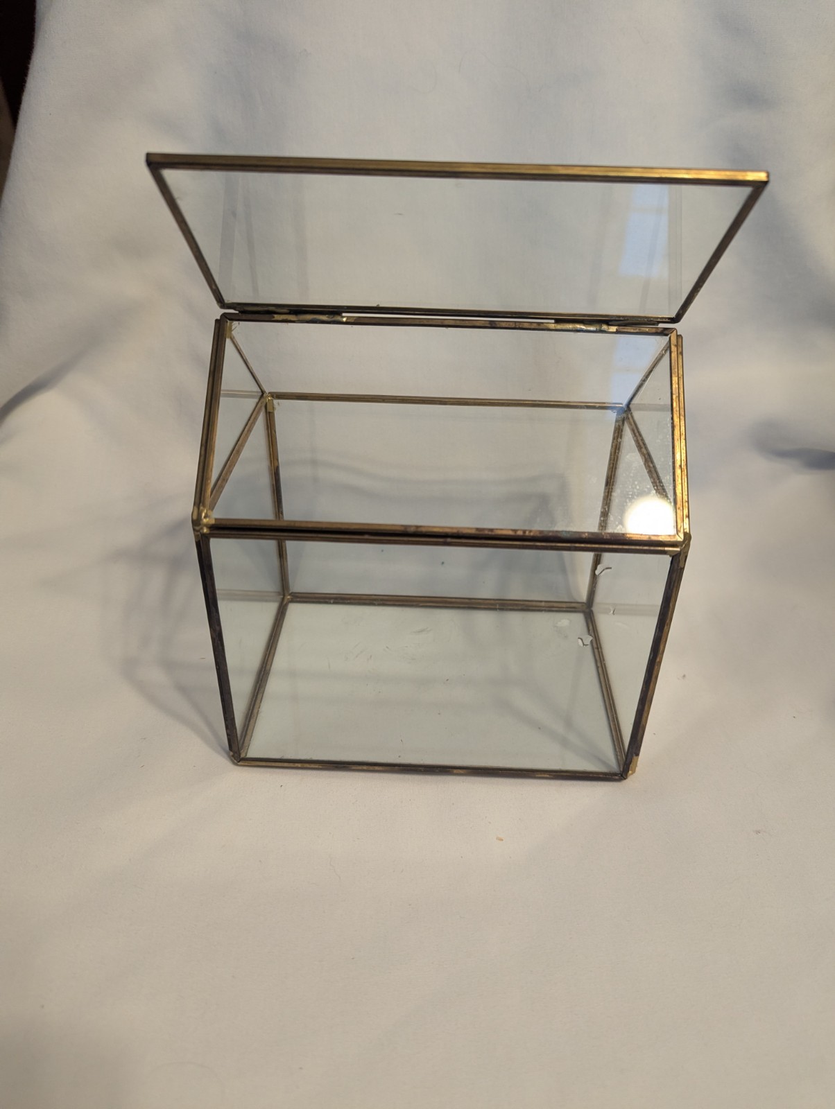 Small house shaped metal and glass terrarium