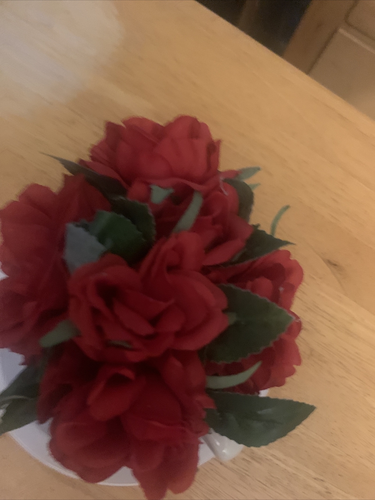 Artificial Red Flowers in Tea Cup and Saucer