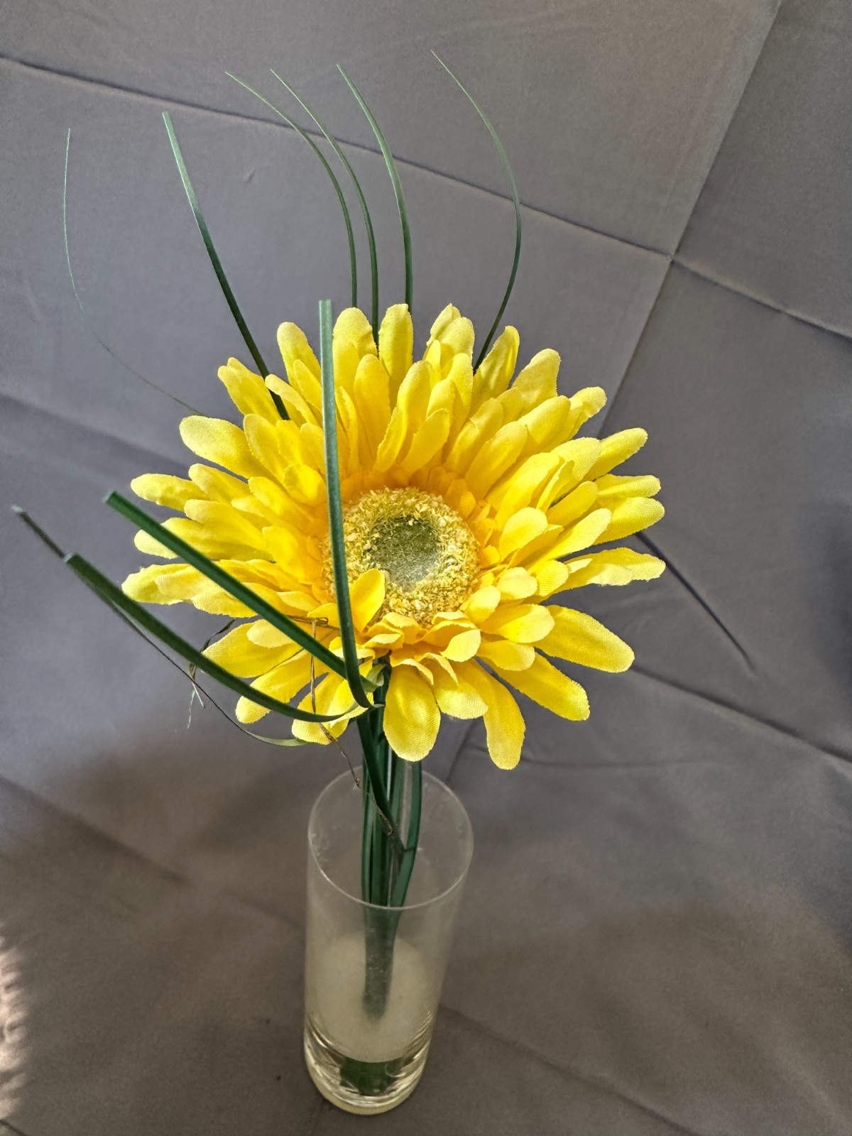 Faux Yellow Gerbera Daisy arrangement in a clear glass cylinder vase