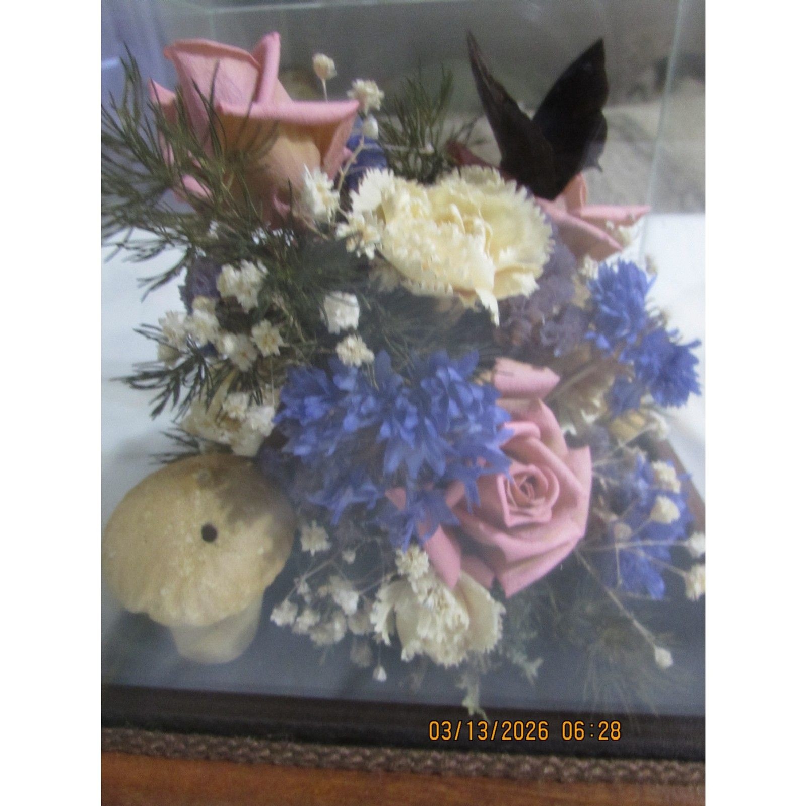 Vintage dried flower arrangement in glass with wood base butterfly mushrooms