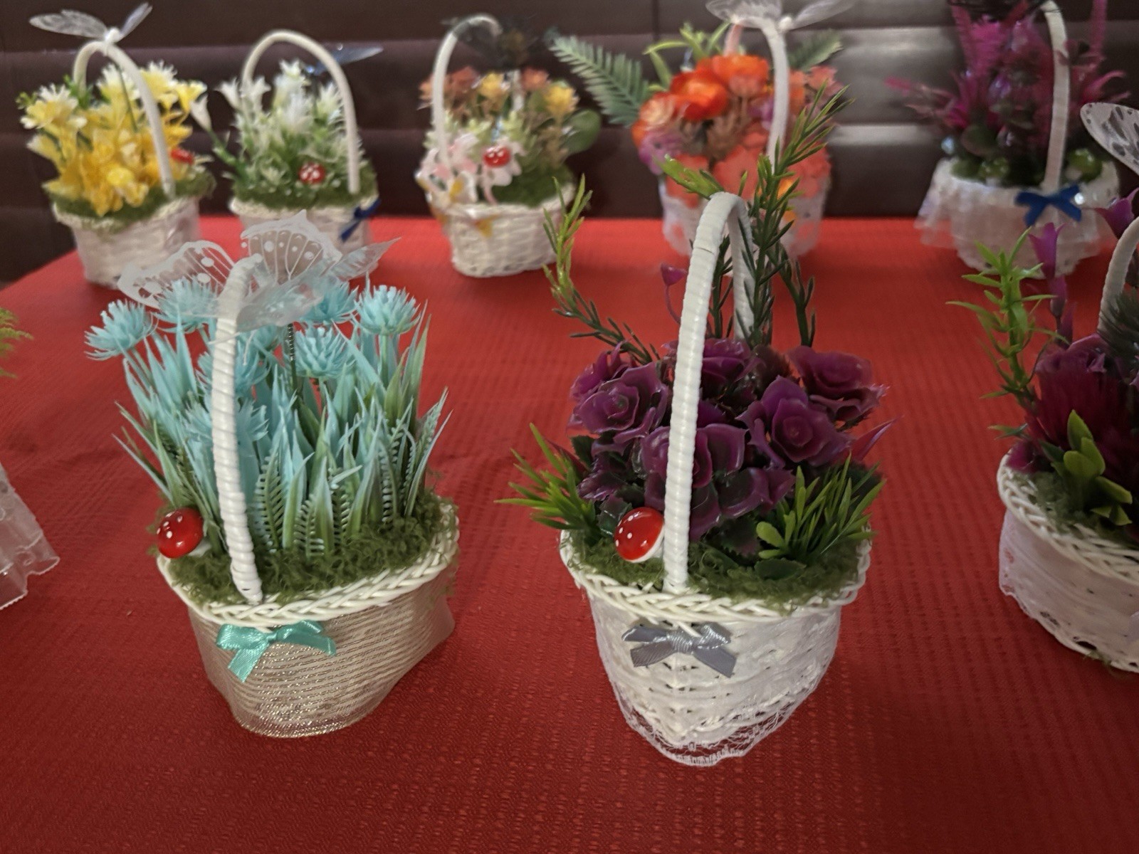 Artificial Floral Arrangement in White Wicker Baskets, Butterfly Accent