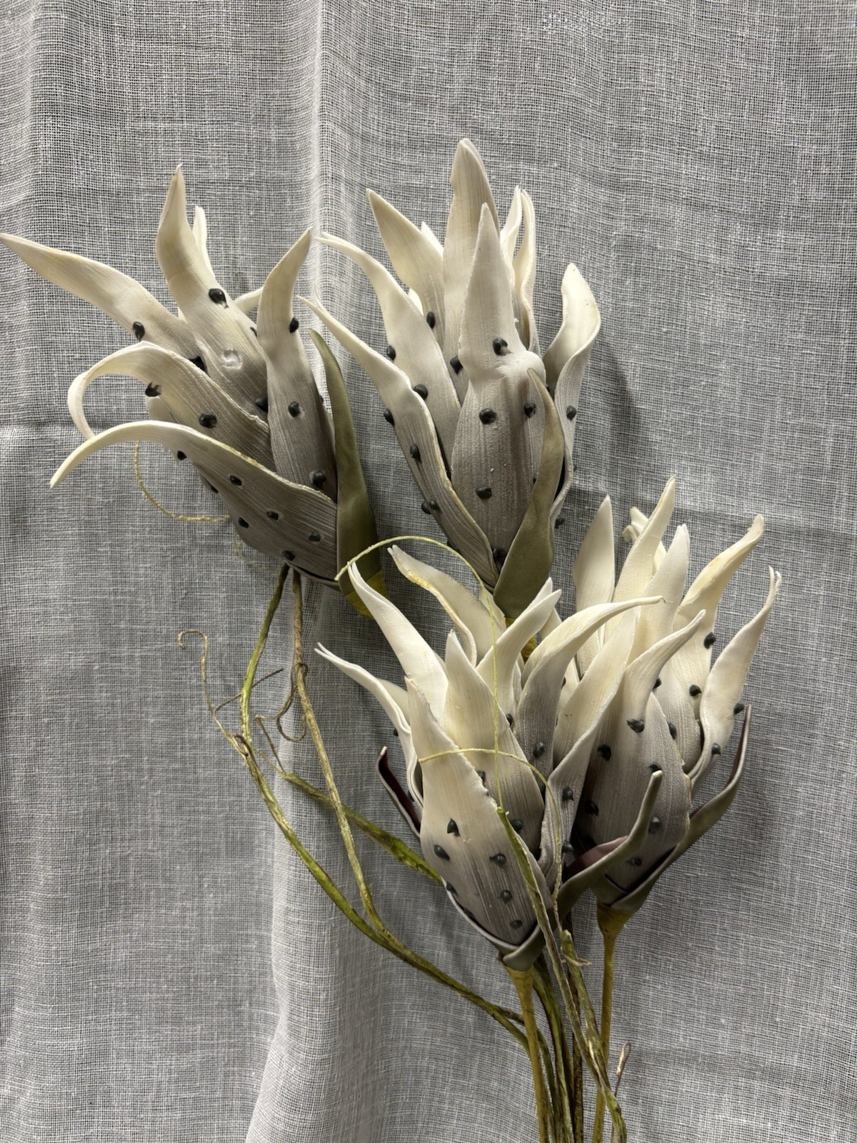 Artificial Flowers Off White and Black Spots with Green Leaves
