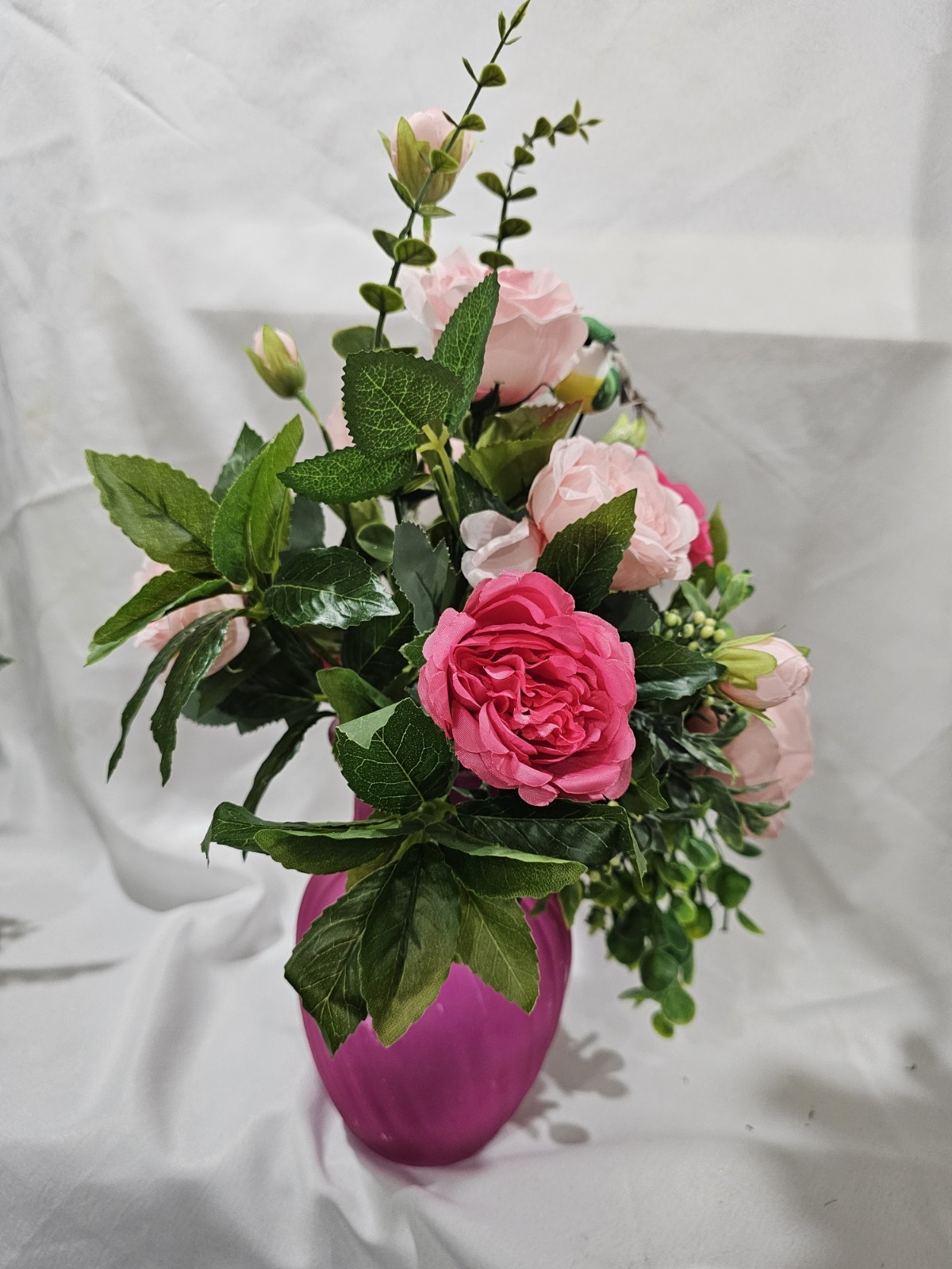 Varied Colors of soft Pink Artificial Roses in a beautiful pink vase