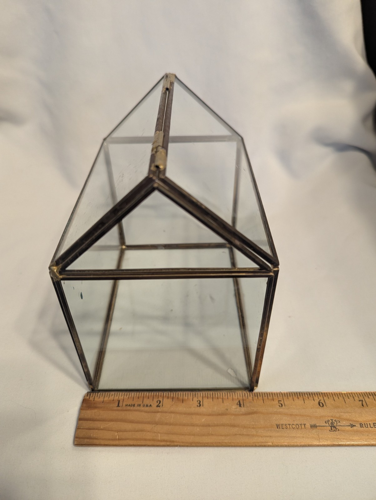 Small house shaped metal and glass terrarium