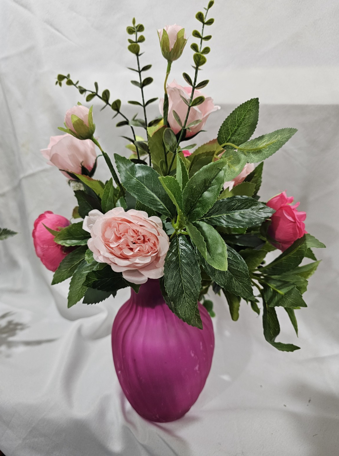 Varied Colors of soft Pink Artificial Roses in a beautiful pink vase