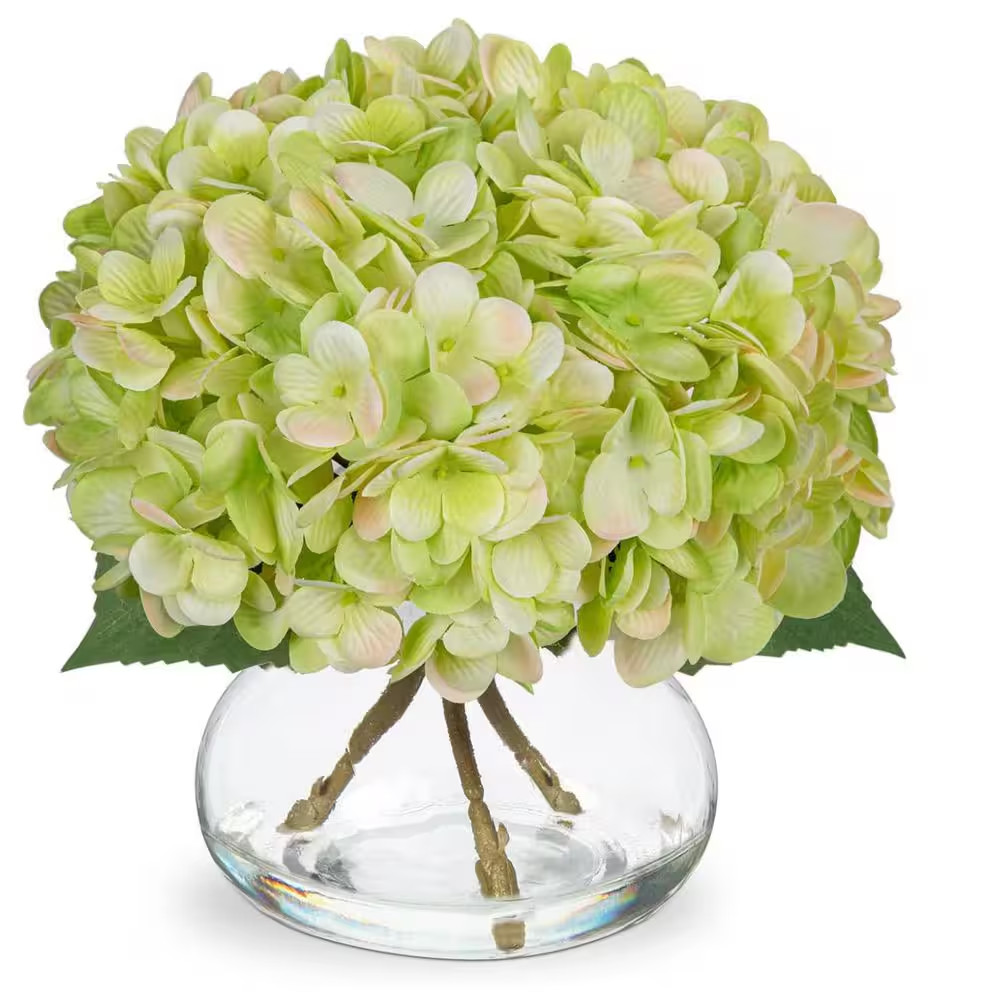 Green Artificial Flowers Paired with a Glass Vase