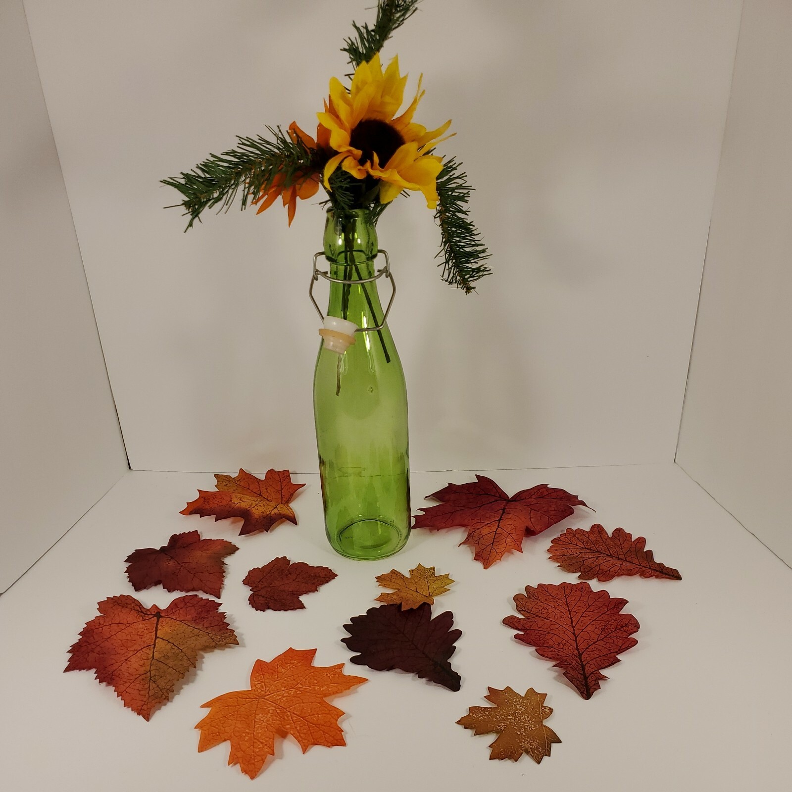 Fall Floral In Green Seal Cap Bottle with Leaves Arrangement Centerpiece