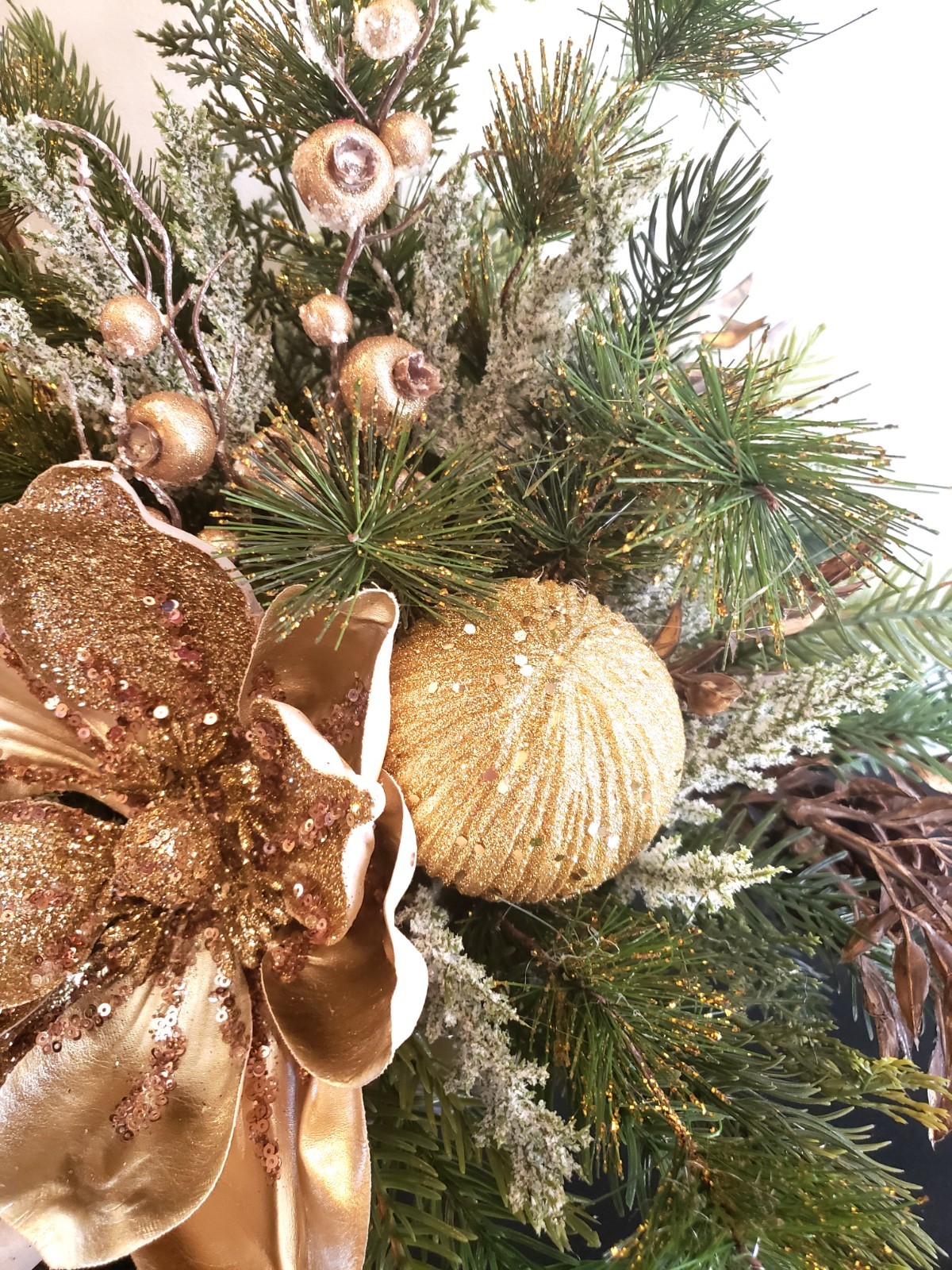 Gold magnolia Christmas floral arrangement, holiday floral arrangement