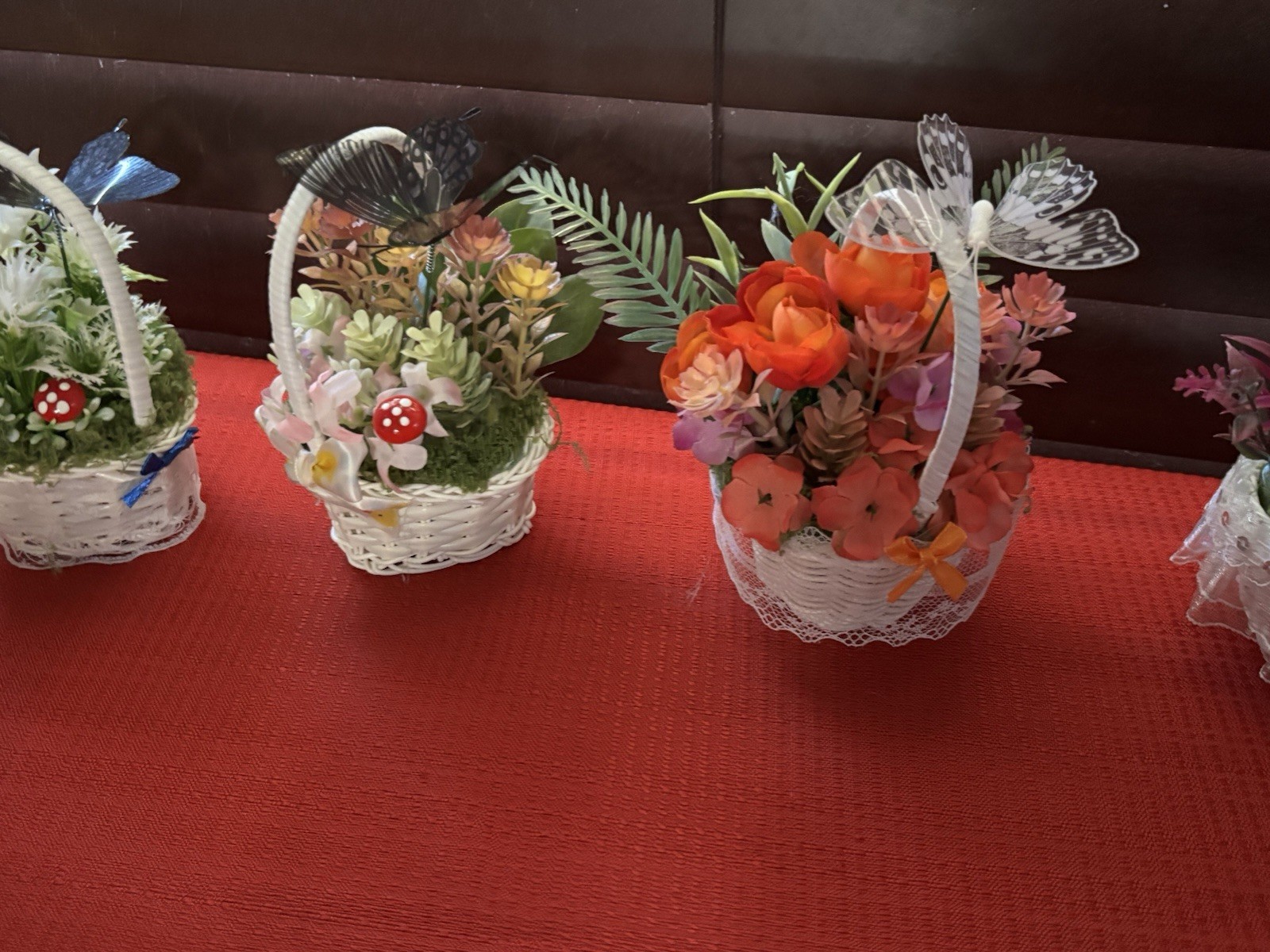 Artificial Floral Arrangement in White Wicker Baskets, Butterfly Accent