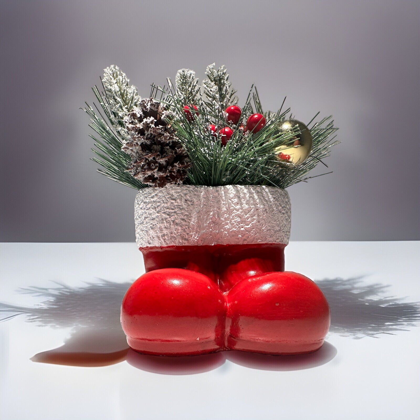Vintage Concrete Pine Christmas Arrangement in A Pair Of Red Santa Clause Boots