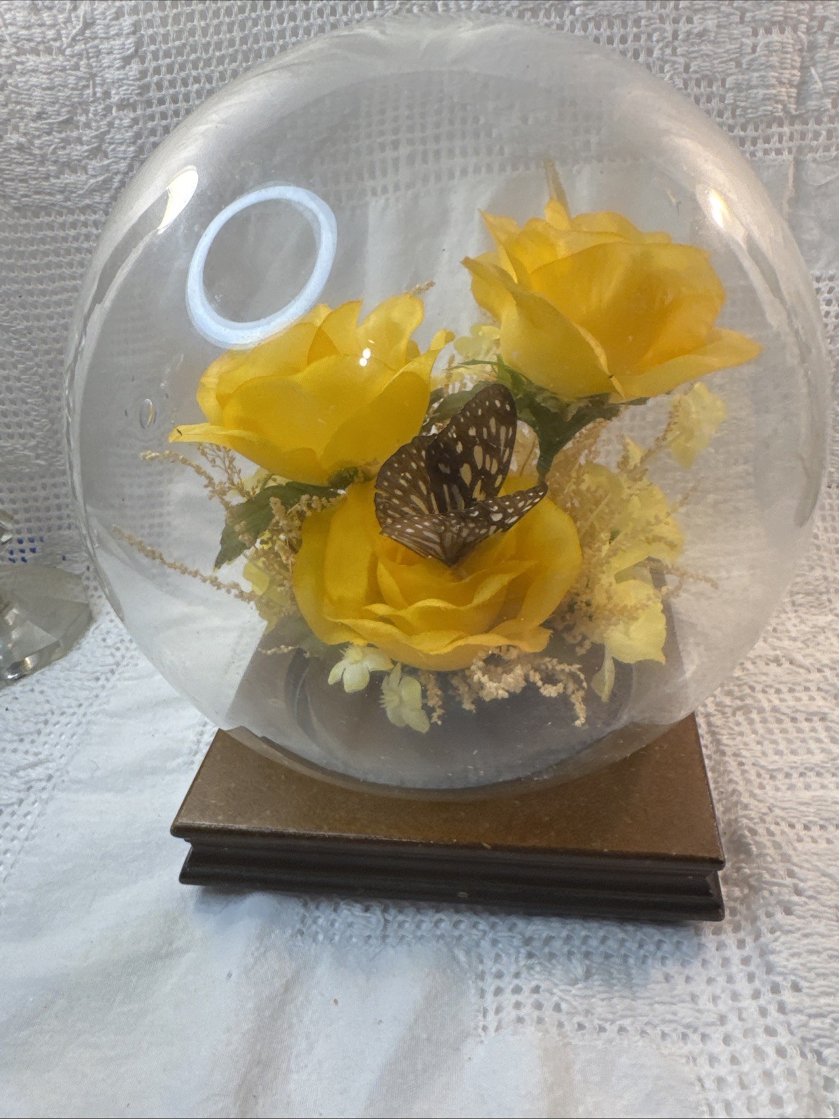 Vintage preserved flower arrangement in glass dome