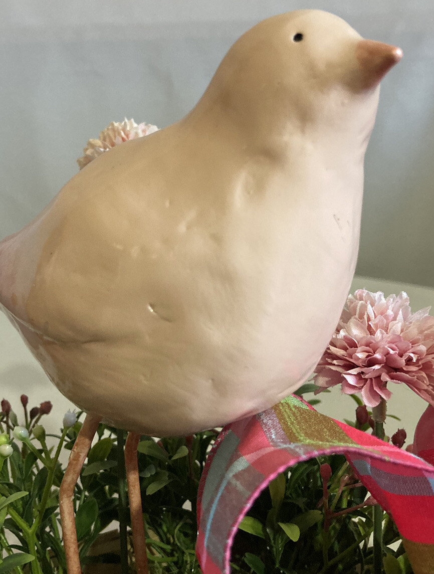 Delightful Pink Bird Surrounded In Boxwood Greenery In A Basket