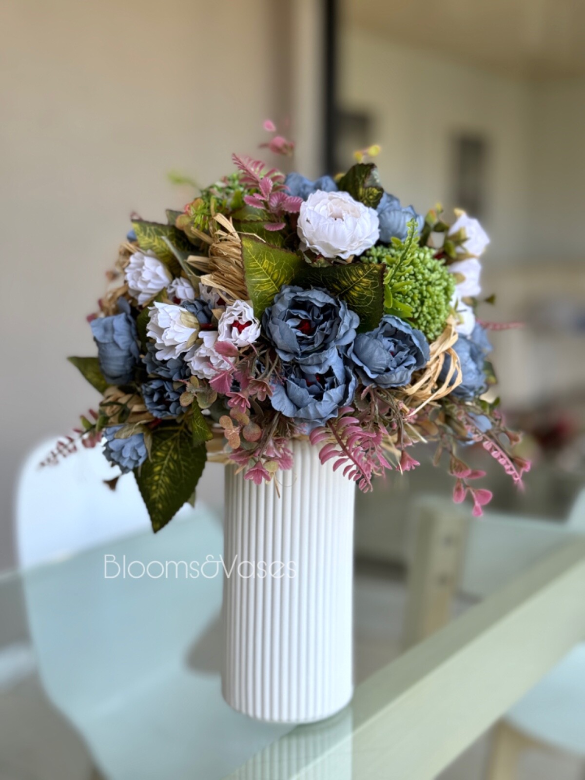 Blue and white flower arrangement in a vase , width 12’, height 15’, home decor.